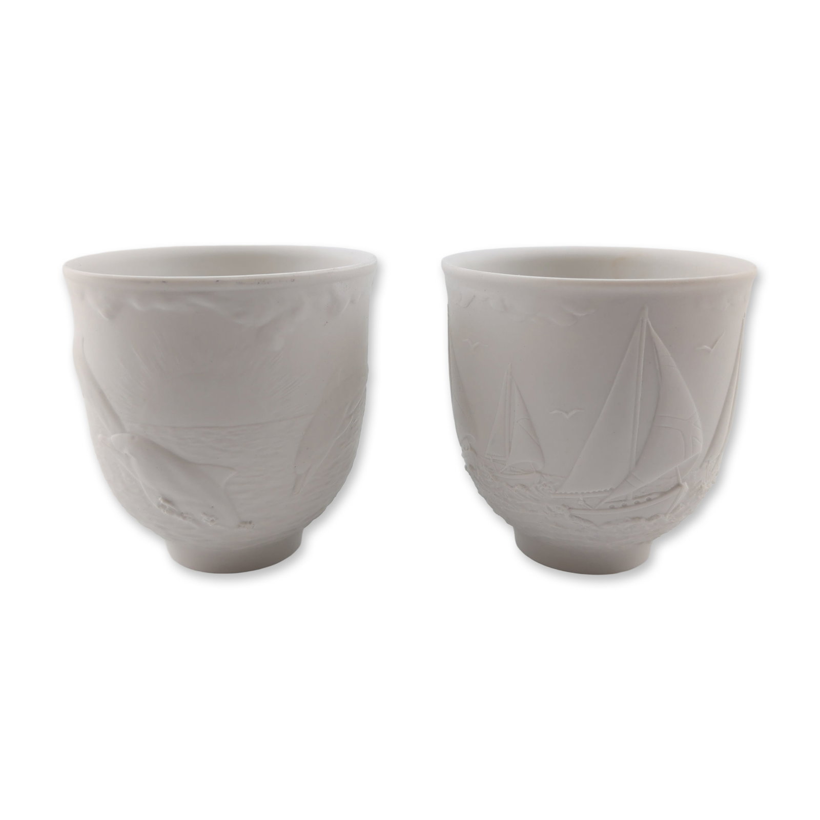 Pair of Lladro Collectors Society Porcelain Votives 17657 and 17658: Lladro. Pair of matte white bisque porcelain votive candleholders from the Collectors Society series. Includes the 1997 annual piece titled Sailing the Seas (Portavela Regata) featuring a relief scene