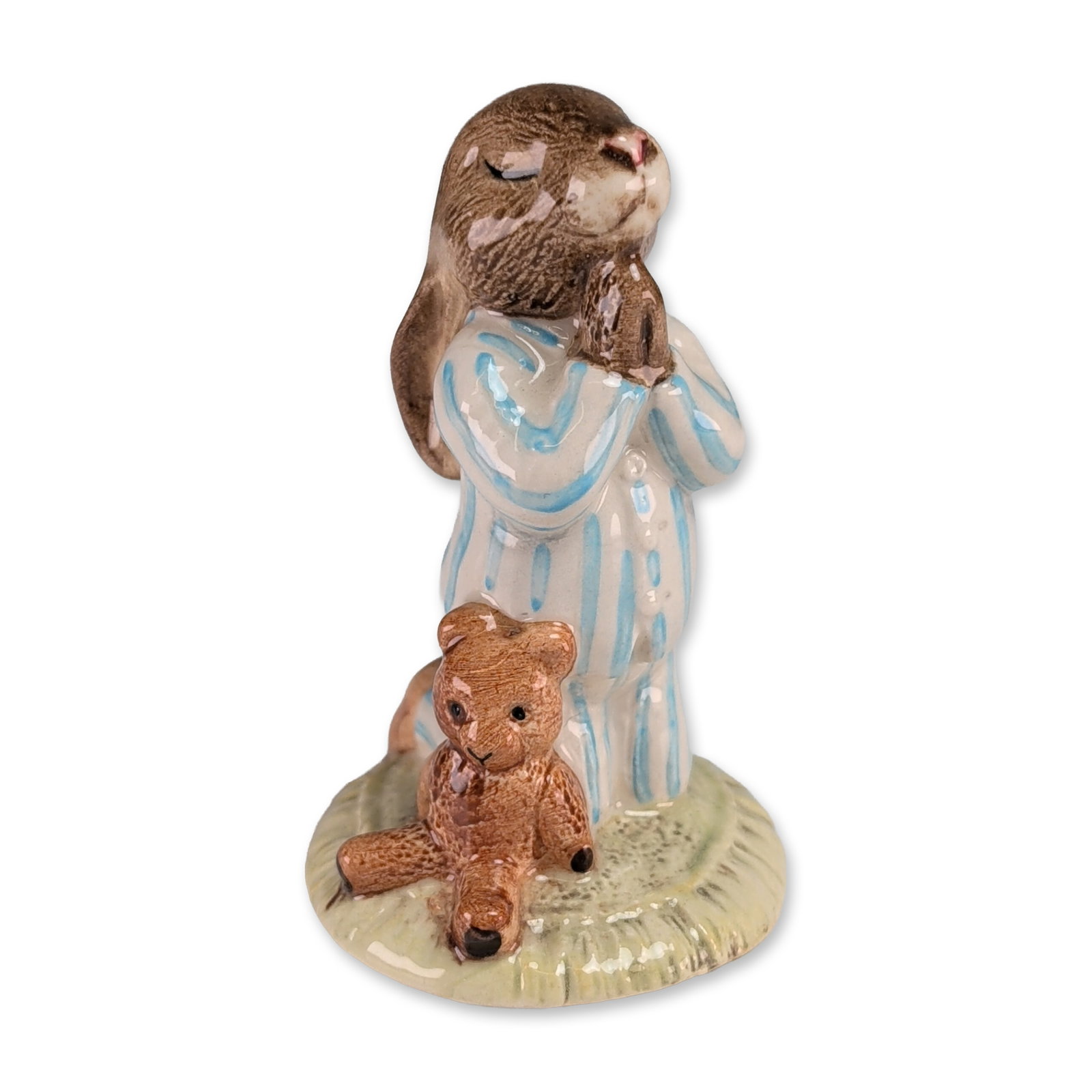 Royal Doulton Bedtime Bunnykins Ceramic Figurine: Royal Doulton glazed ceramic figurine titled Bedtime, model number DB 55. The piece depicts a brown rabbit wearing blue and white striped pajamas in a kneeling prayer pose, accompanied by a small brow