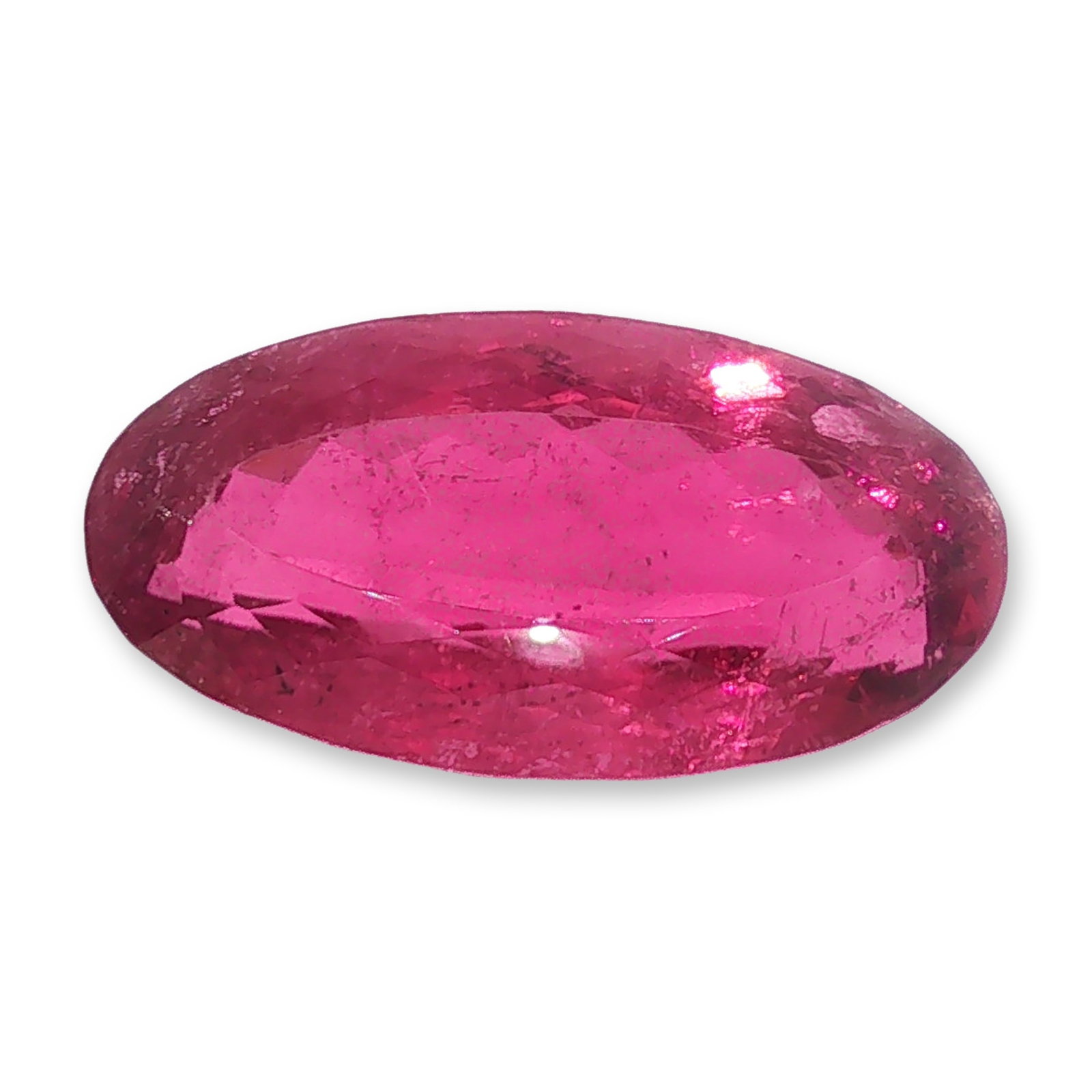 Pink Tourmaline 20.6ct Gemstone: Loose faceted gemstone pink tourmaline, featuring a vibrant pinkish-red hue characteristic of the variety. The stone is worked in an oval cut designed to maximize surface area, with vivid color satura