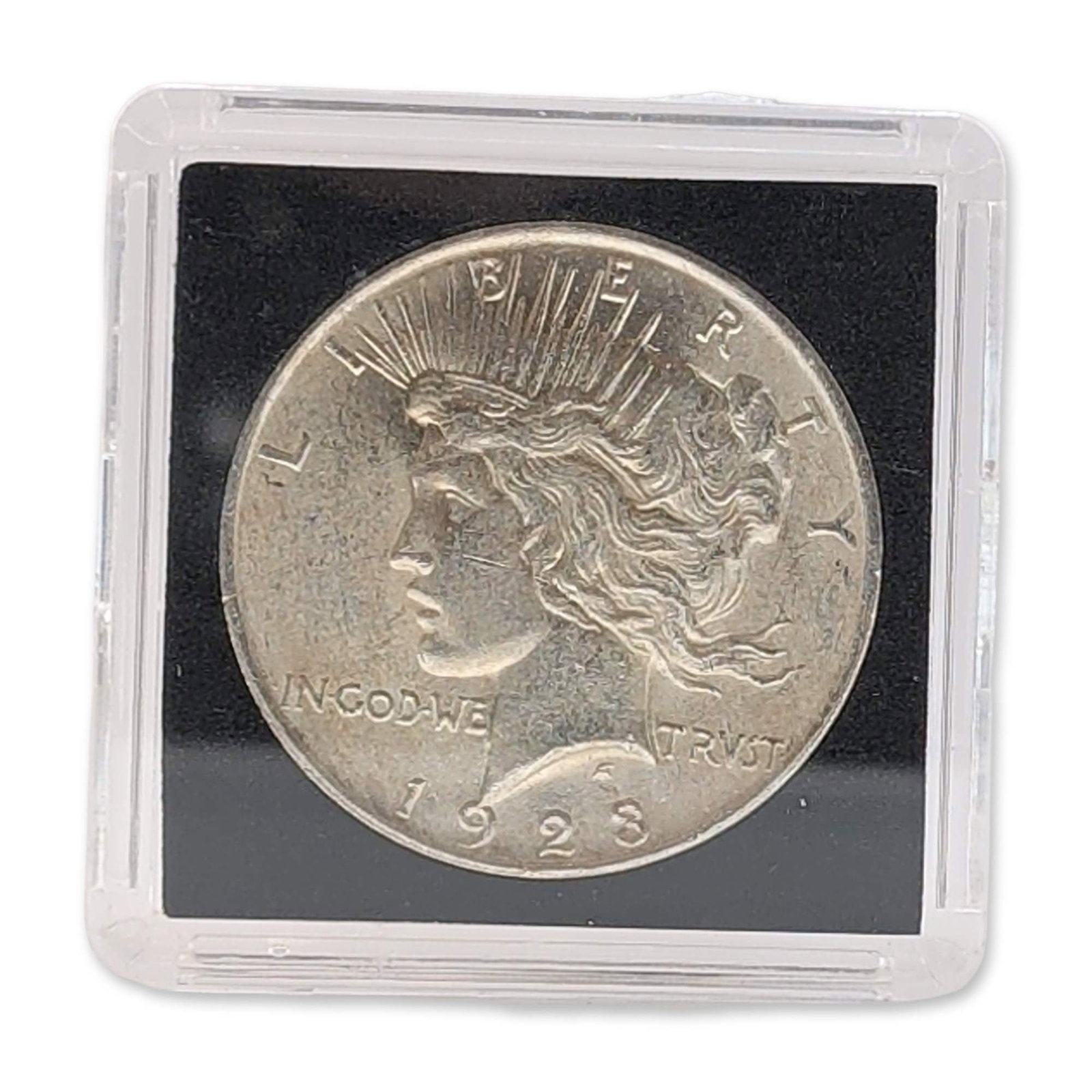 1923 US Peace Silver Dollar: 1923 US Peace silver dollar struck at the Philadelphia Mint. Composed of 90% silver. Obverse features Liberty with radiate crown. Reverse depicts eagle on rock with rising sun. Inscribed with LIBERTY,