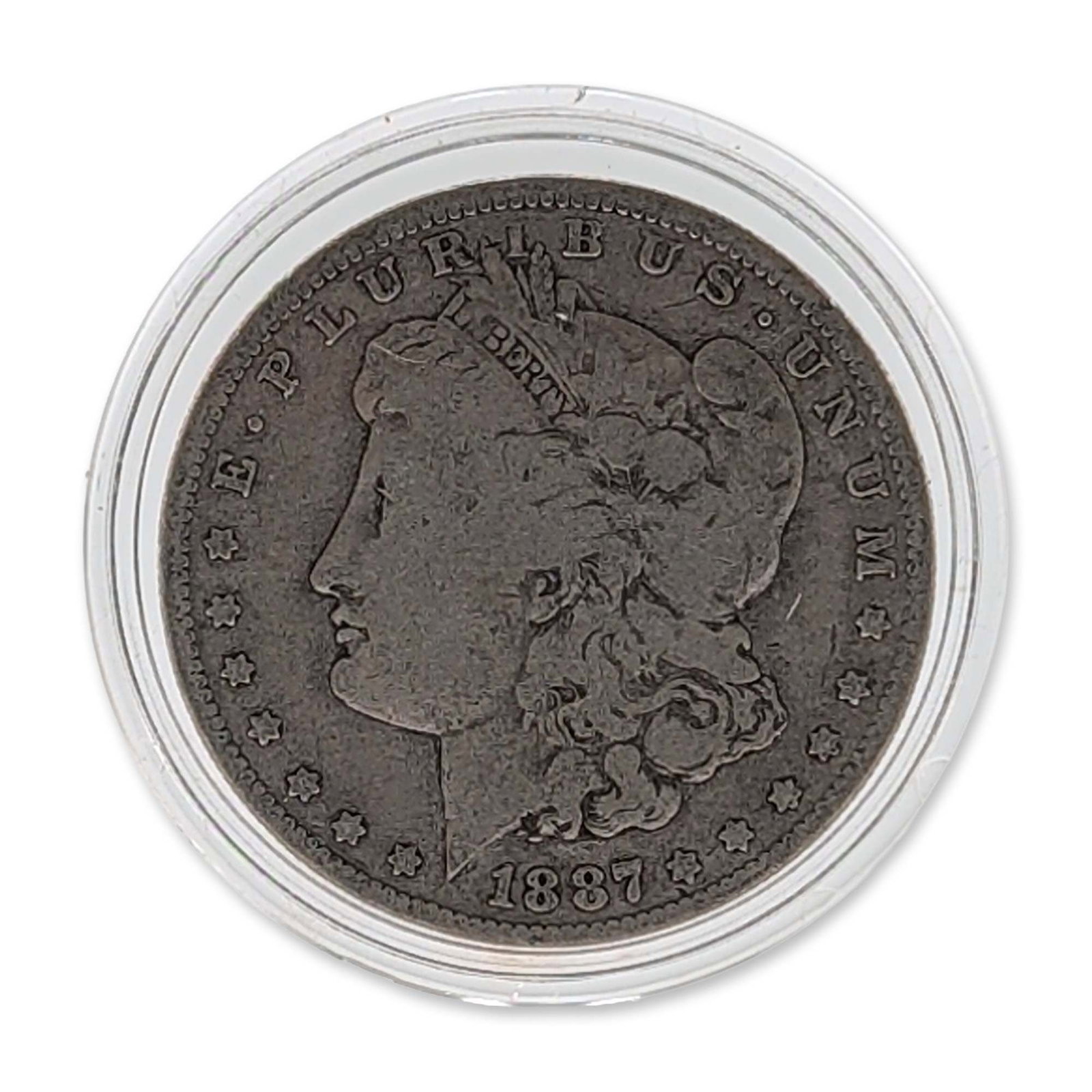 US 1887 Morgan Silver Dollar: US Mint 1887 Morgan silver dollar, struck in 90 percent silver. Obverse depicts Liberty in profile wearing a Phrygian cap with the legend E PLURIBUS UNUM and the date 1887. Reverse displays a
