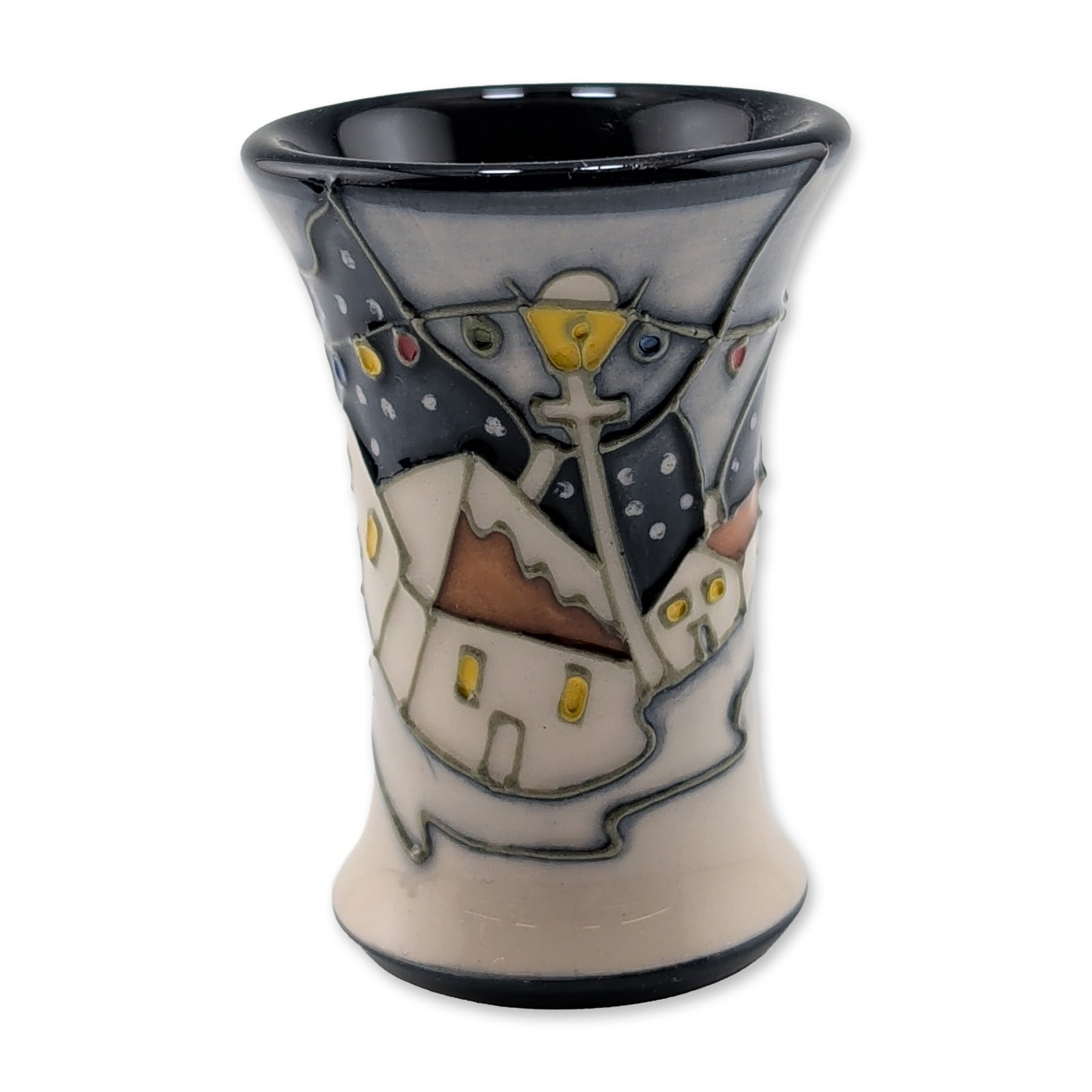 Moorcroft Pottery Miniature Vase, Whitby Harbour: Moorcroft ceramic miniature flared cylindrical vase, featuring an abstract stylized village scene at night. The design includes geometric houses with yellow windows set against a dark blue sky with wh