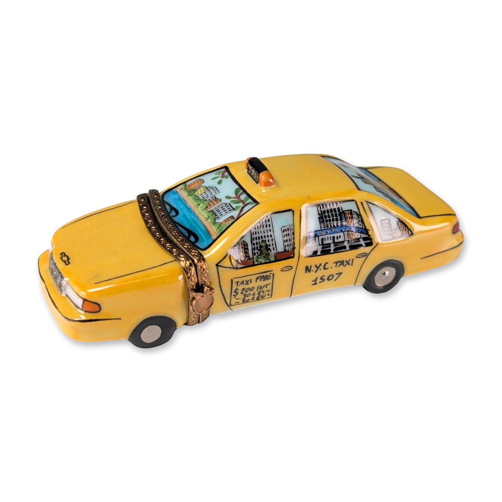 Carenton Limoges Hand Painted New York Taxi Porcelain Box: Limoges, France, hand-painted porcelain trinket box in the form of a yellow New York City taxi cab. The exterior features vignettes of the Manhattan skyline and the Statue of Liberty, along with stand