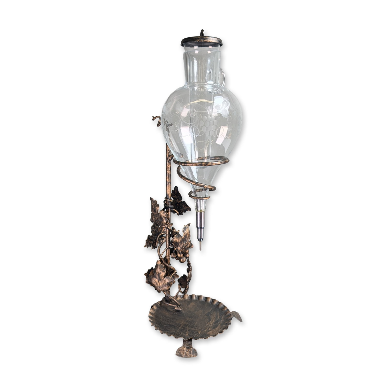 Austrian Wrought Iron and Etched Glass Wine Dispenser: Austrian, mid-20th century. Wine dispenser in wrought iron and etched glass, featuring a teardrop-form clear glass vessel with an etched grapevine and leaf motif, a side-mounted loop handle, and a nee
