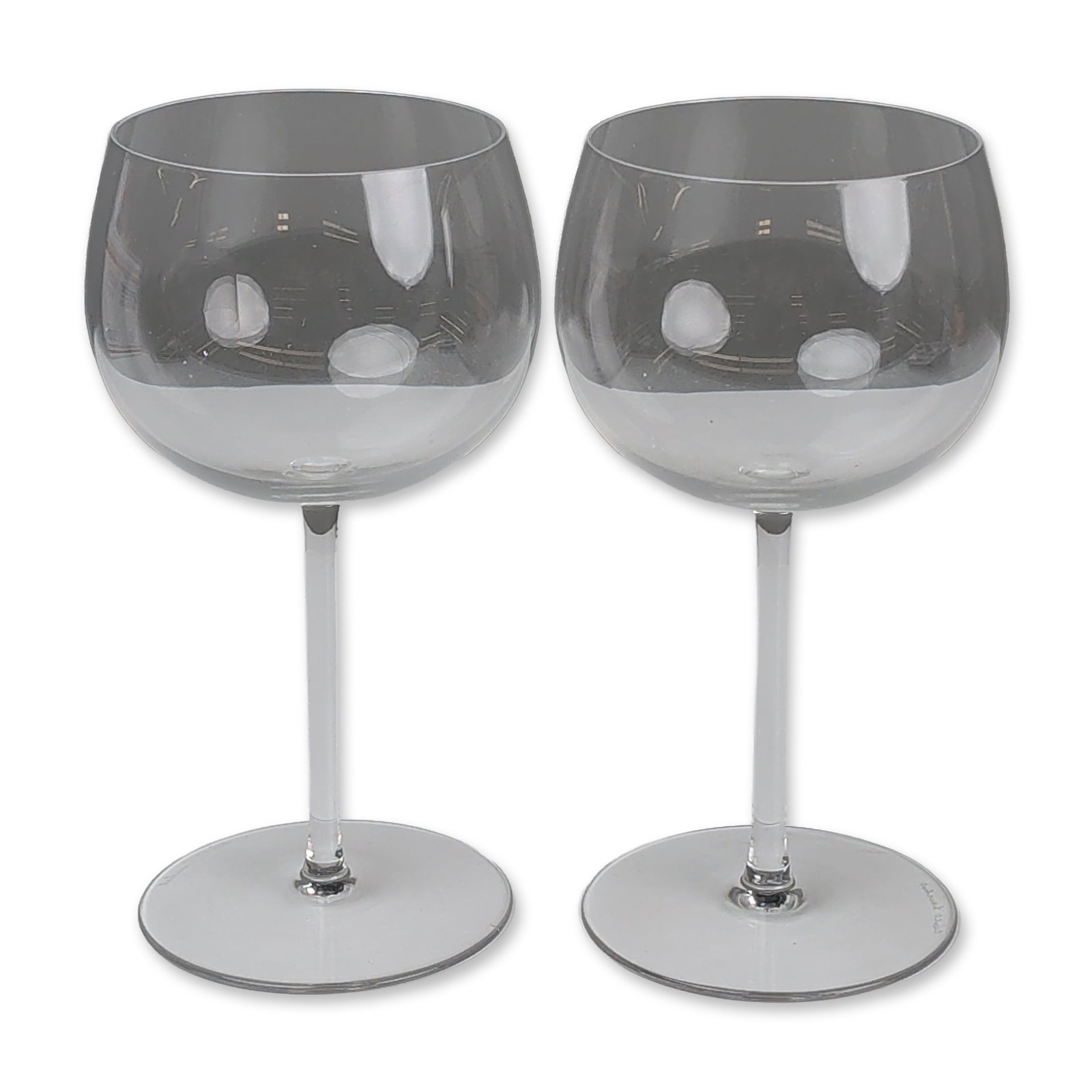 Pair of Val Saint Lambert Crystal Balloon Glasses: Pair of balloon-style wine glasses in clear lead crystal, featuring large rounded bowls with tapered rims, slender straight stems, and flat circular feet. Each piece bears an etched script signature f