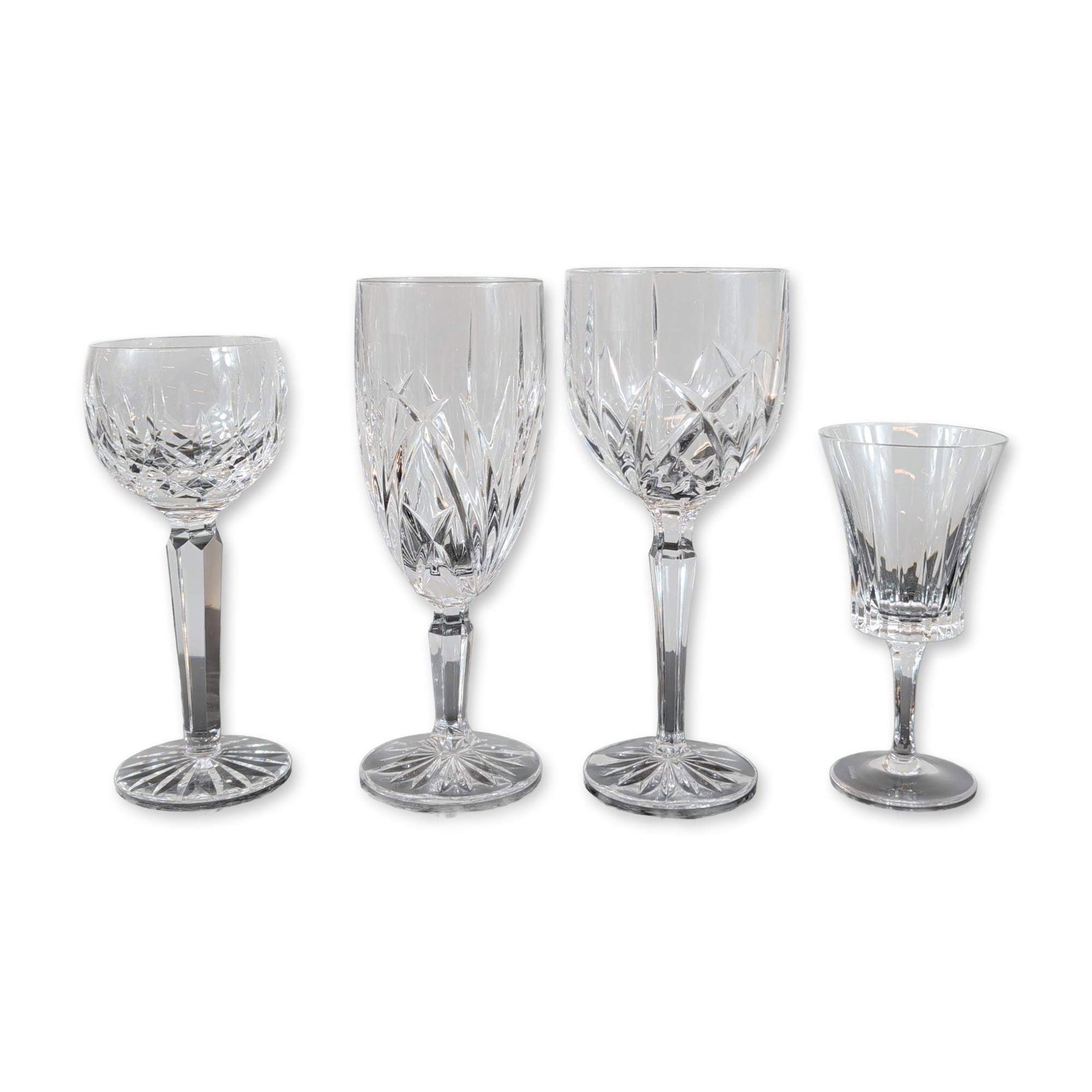 Group of Four Marquis by Waterford and Gorham Crystal Stemware: Marquis by Waterford and Gorham. Group of four stemware pieces in lead crystal, featuring assorted cut patterns including Brookside and Hanover styles. One flared port glass by Gorham displays vertica