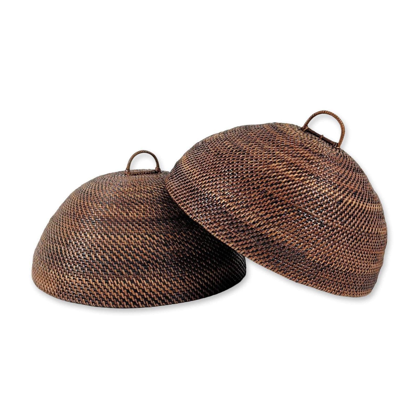 2pc Southeast Asian Rattan Food Covers: Southeast Asian. Pair of dome-shaped food covers or cloches in dark brown woven rattan, featuring a fine, tight spiral weave radiating from the center. Each piece includes an integrated woven loop han