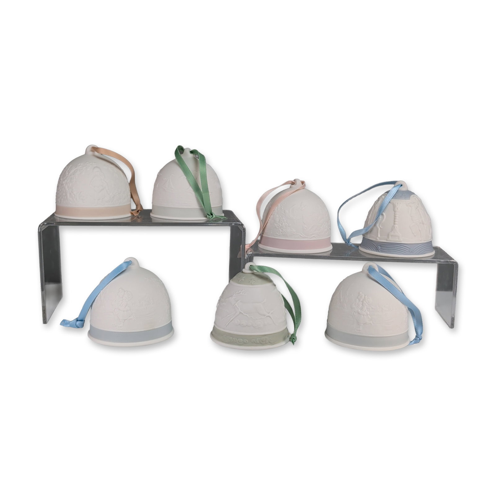 7pc Lladro Porcelain Bells: Lladro Collectors Society, Spain. Set of seven annual commemorative bells in matte porcelain, dating from 1988 to 1994. Decorative elements include a single-color band at the base and a coordinating h
