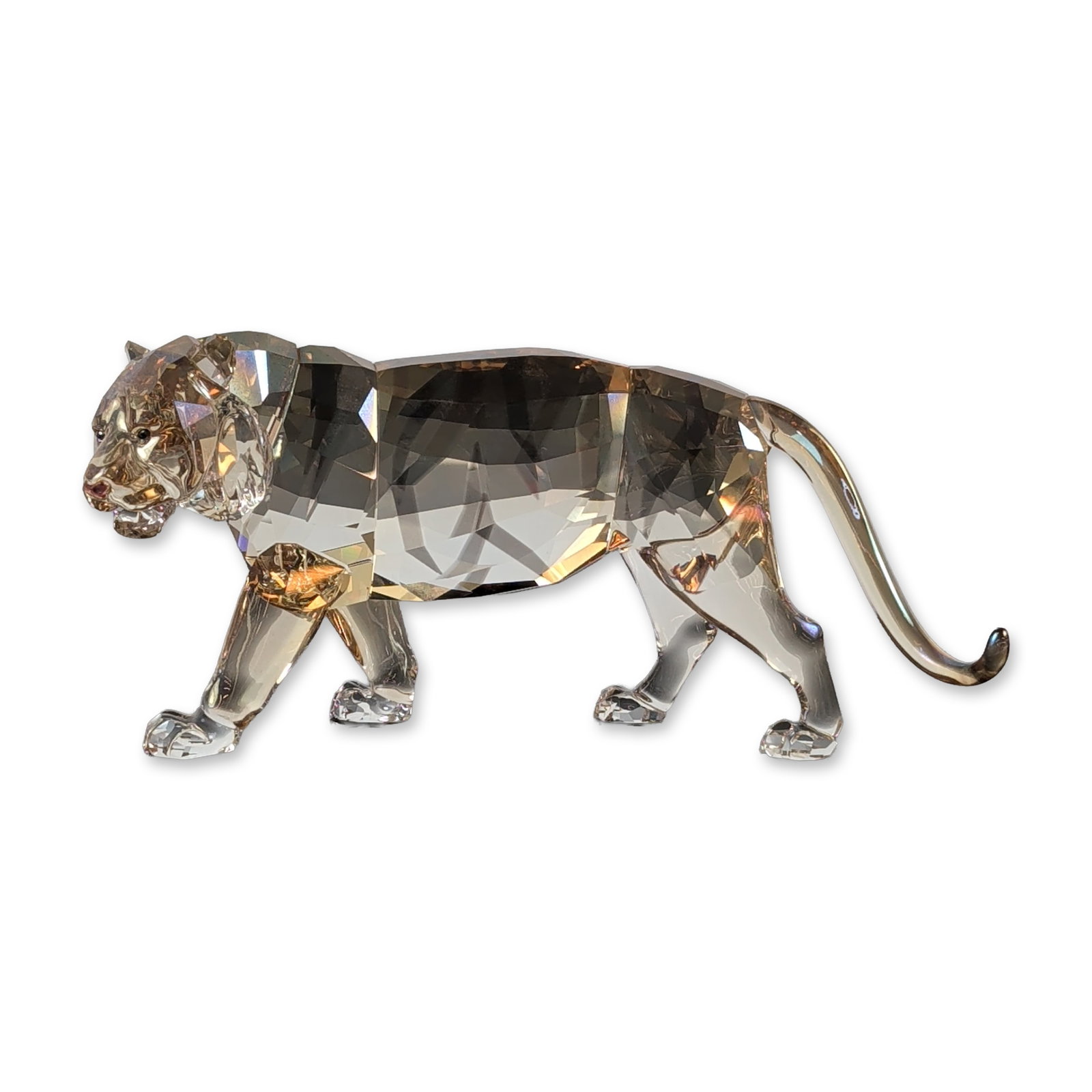 Swarovski SCS 2010 Tiger Golden Shine Crystal Figurine: The Swarovski SCS 2010 Annual Edition Tiger figurine (#1003148) is the dramatic finale of the "Endangered Wildlife" trilogy. Designed by Elisabeth Adamer, the majestic figure is masterfully crafted in