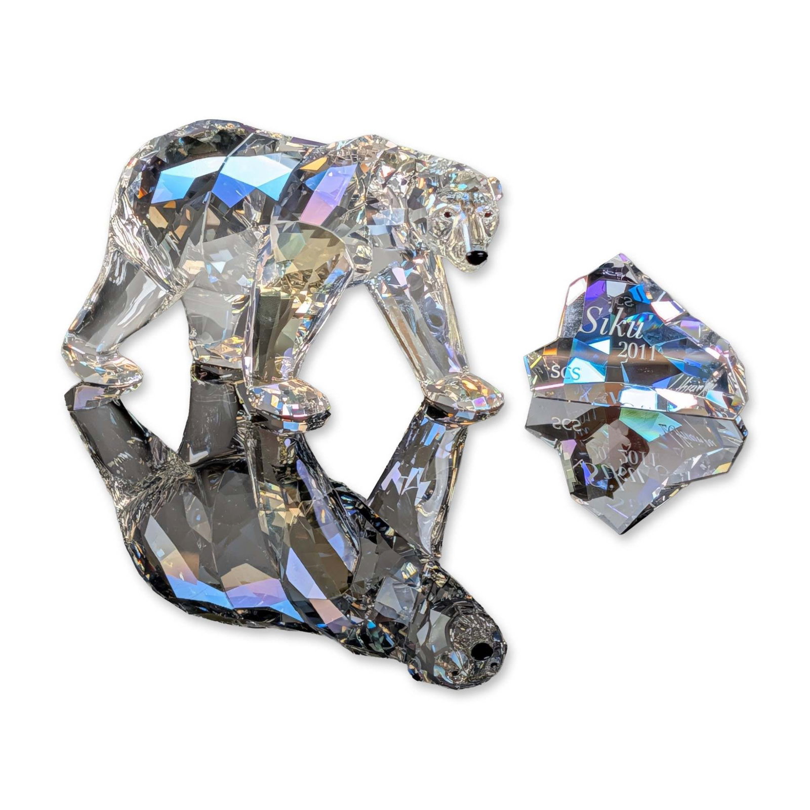 Swarovski SCS Crystal 2011 Annual Edition Figurine, Siku Polar Bear with Iceberg Plaque: Swarovski Crystal Society Annual Edition 2011 Siku polar bear figurine and accompanying title plaque. The faceted clear crystal bear is depicted in a naturalistic walking pose and features jet crystal