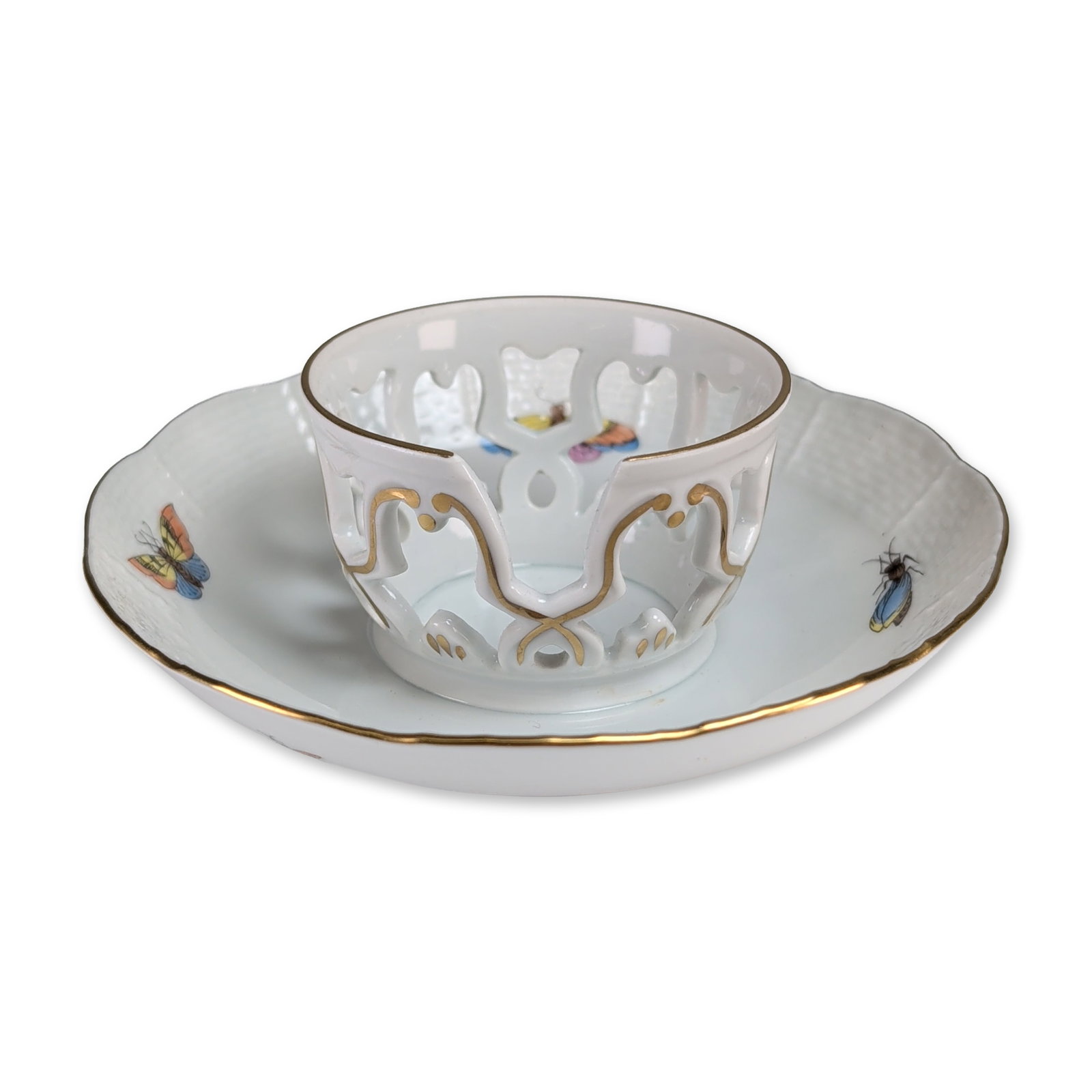 Herend Rothschild Reticulated Trembleuse: Herend, Hungary. Trembleuse in hand-painted porcelain. The set features a double-walled cup with a pierced, reticulated outer shell and a saucer with a deep central gallery designed to secure the vess