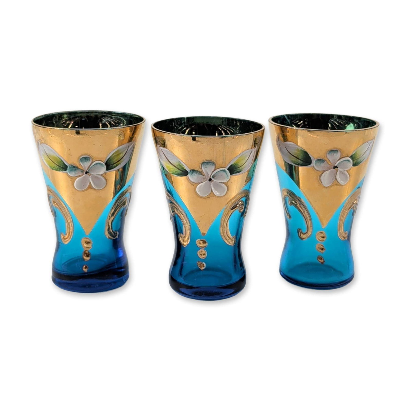 3pc Italian Gold Liqueur Glasses: Venetian liqueur glasses crafted in the Tre Fuochi style. Hand-blown glass forms with turquoise bodies and deep cobalt blue bases. Extensively decorated with 24 karat gold gilding and hand-painted