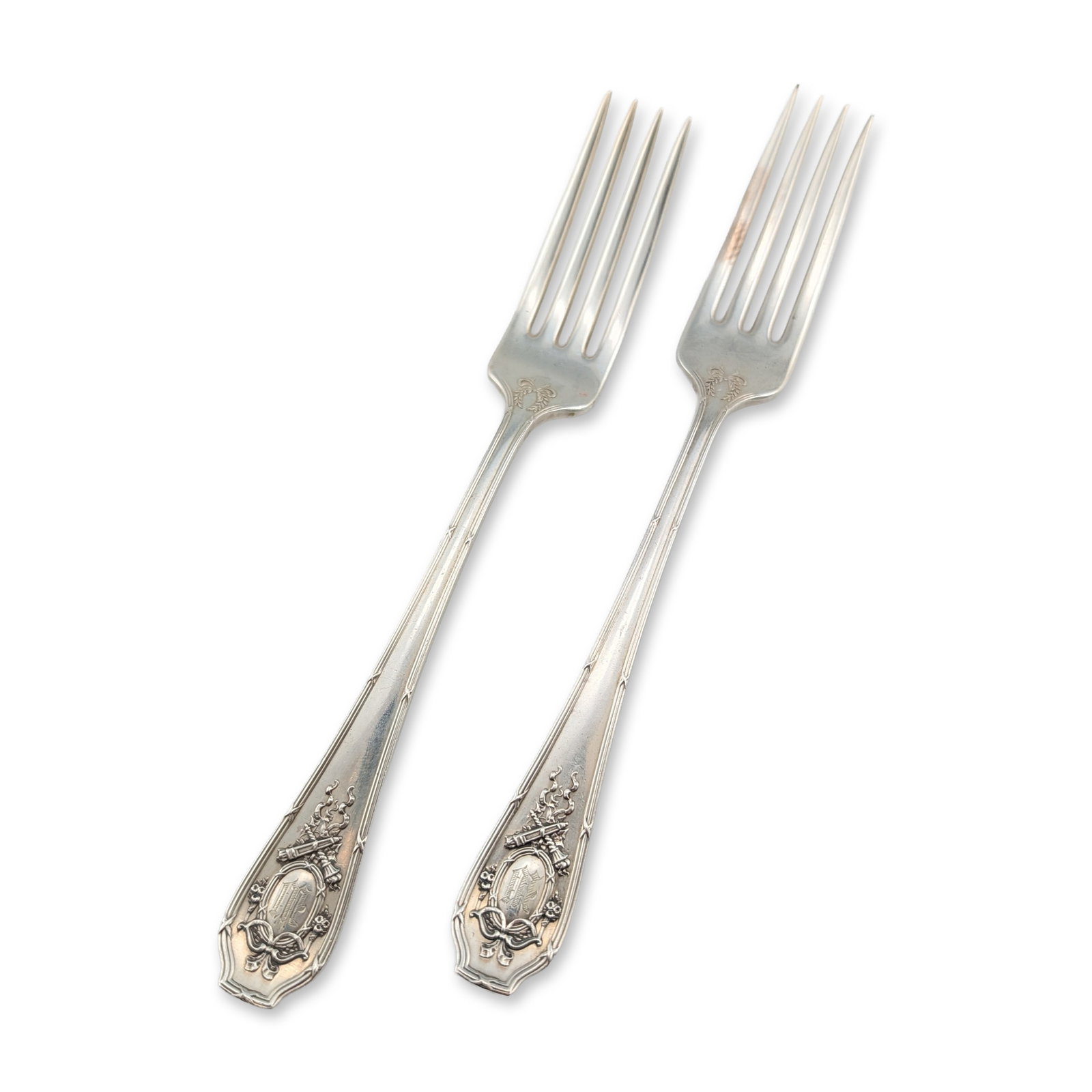 2pc R. Wallace & Sons Sterling Silver Forks: Pair of sterling silver forks featuring a Neoclassical motif with a central oval medallion topped by a ribbon bow and flanked by floral swags. The medallions are engraved with a Gothic-style monogram 