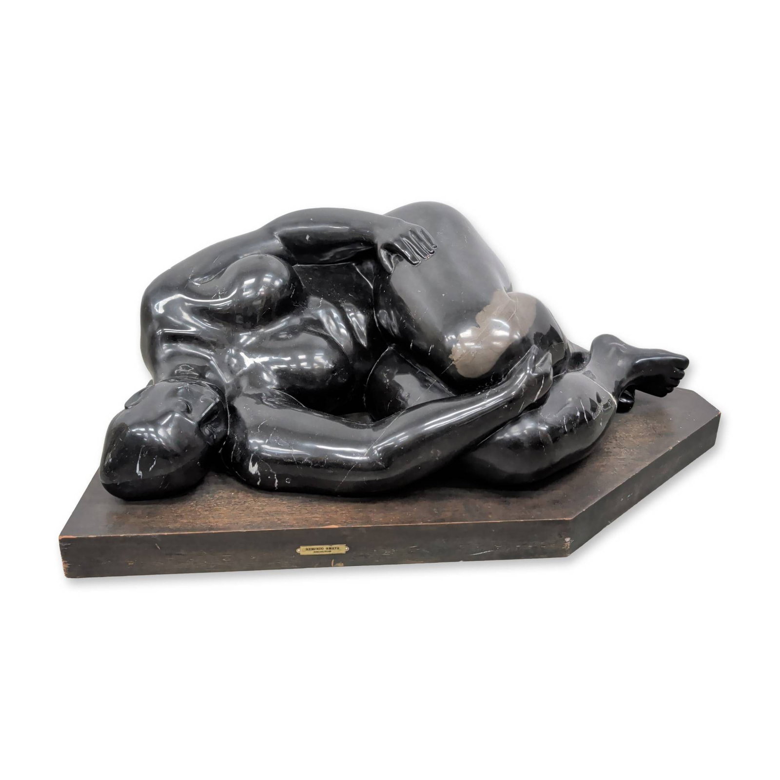 Armando Amaya (Mexican, b. 1935) Black Marble Reclining Nude, Signed: Armando Amaya reclining female nude sculpture in hand-carved black marble, dated 1977. The work features stylized, voluminous forms characteristic of the artist's modernist aesthetic, with a highly po
