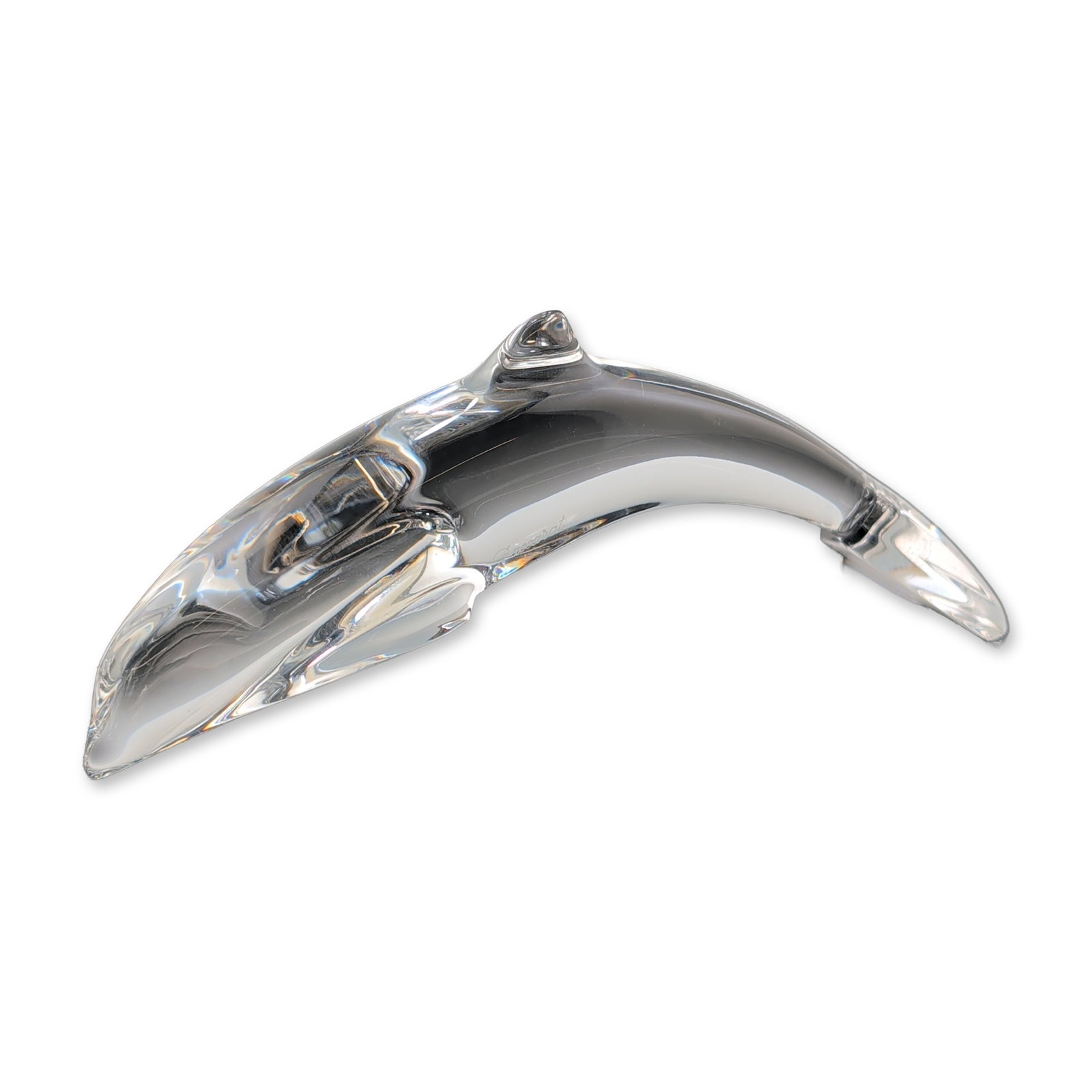 Baccarat France Clear Crystal Diving Dolphin Figurine: Baccarat, France. Diving dolphin figurine in clear lead crystal, featuring a minimalist, stylized form in a leaping posture. The base features a circular acid-etched maker mark containing a goblet,