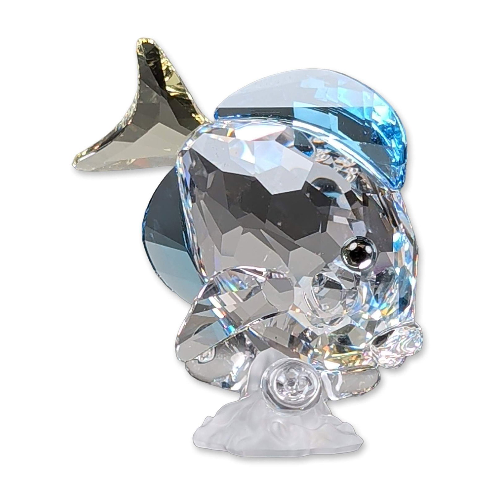 Swarovski Crystal Figurine, Blue Tang Fish: Swarovski crystal 2007 figurine from the Wonders of the Sea series. Figurine made with a clear faceted body with inset black eyes. The piece is accented with blue crystal dorsal and ventral fins and