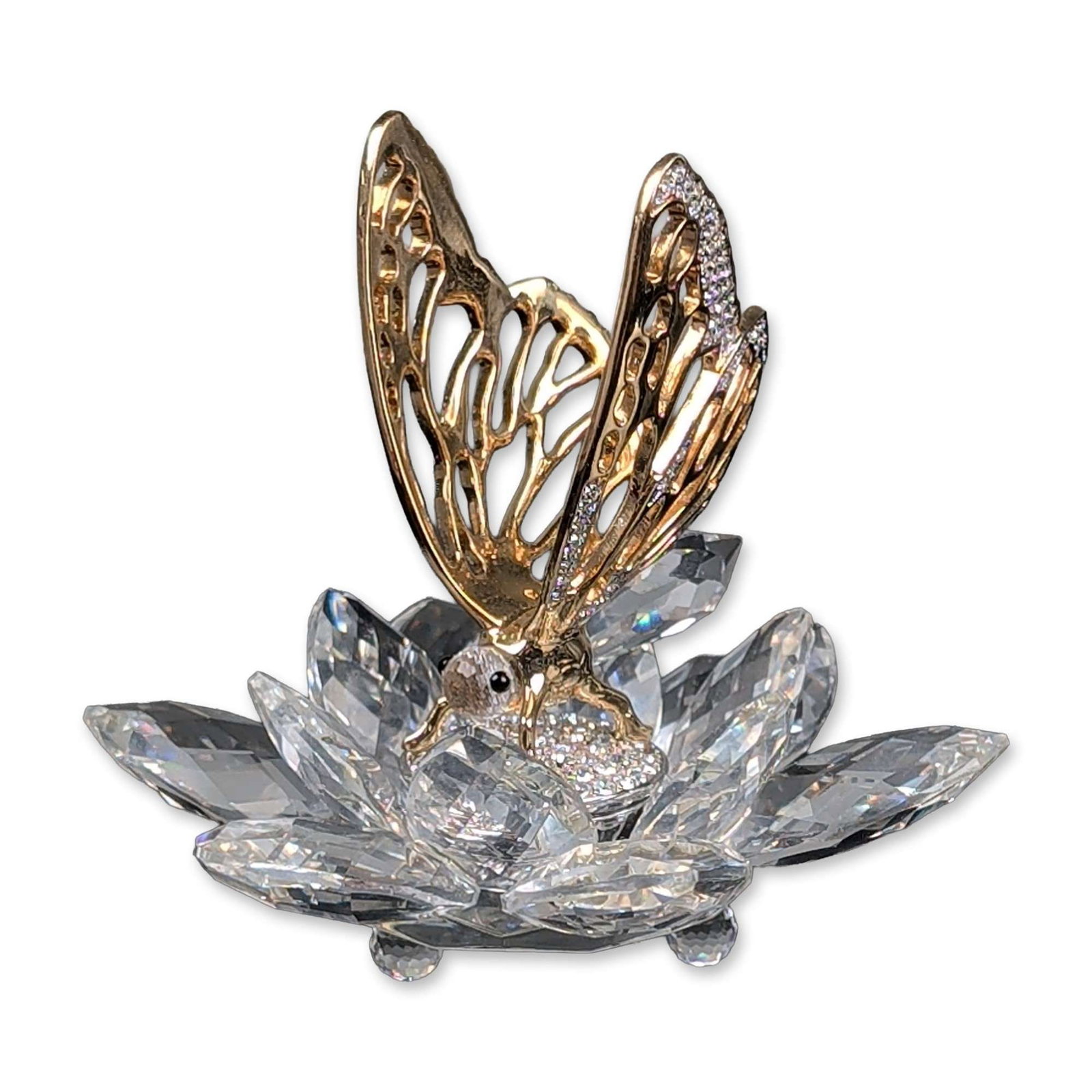 Swarovski Crystal Figurine, In Flight Butterfly - Gold: The figurine features a gold-tone metal butterfly with openwork filigree wings and pave-set crystal accents mounted on a faceted clear crystal lotus-form base. The butterfly head is embellished with