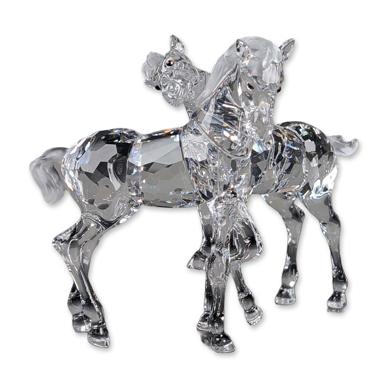 Swarovski Crystal Figurine, Foals: Swarovski figure is depicted as two horses intertwined in play. The figurine features have frosted crystal mane and tail. Includes the original blue Swarovski presentation box with silver lettering an