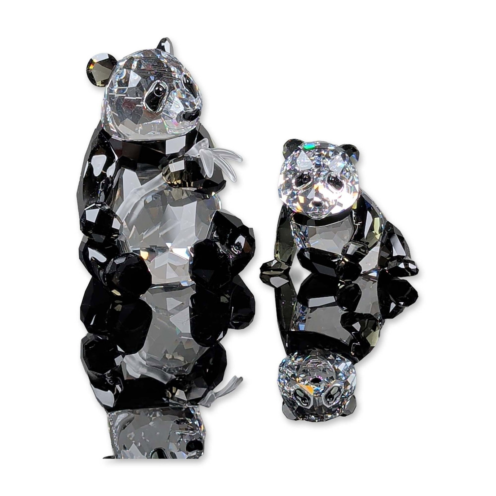 2pc Swarovski 2008 SCS Pandas Crystal Figurines: Swarovski Crystal Society 2008 Annual Edition Pandas set designed by Heinz Tabertshofer. The set comprises a seated mother panda holding a frosted crystal bamboo branch and a reclining panda cub. Each