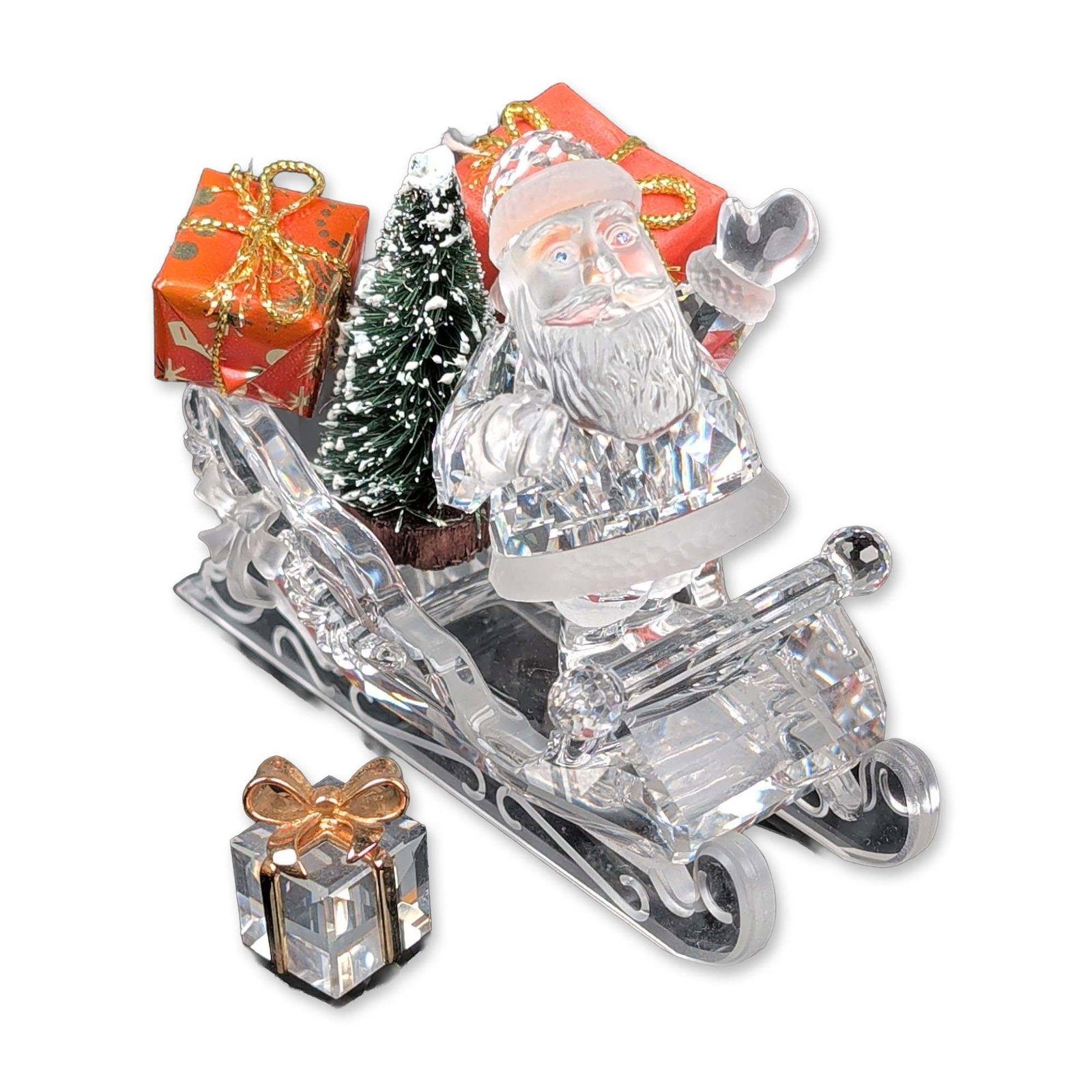 2pc Swarovski Silver Crystal Santa and Sleigh Figurines: Swarovski Silver Crystal faceted lead crystal holiday set. Santa Claus figurine features frosted accents on the beard, hat trim, and coat cuffs. Sleigh features a faceted body and scrolled crystal run