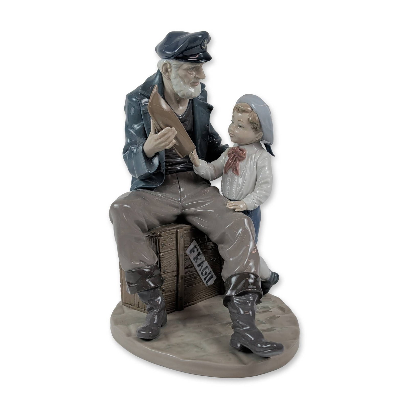 Lladro Spanish Glazed Porcelain Figurine A Tall Yarn: Lladro (Spain). Glazed porcelain figurine titled A Tall Yarn, model number 5207, designed by Salvador Furio. The multi-figure composition depicts an elderly sailor with a white beard wearing a