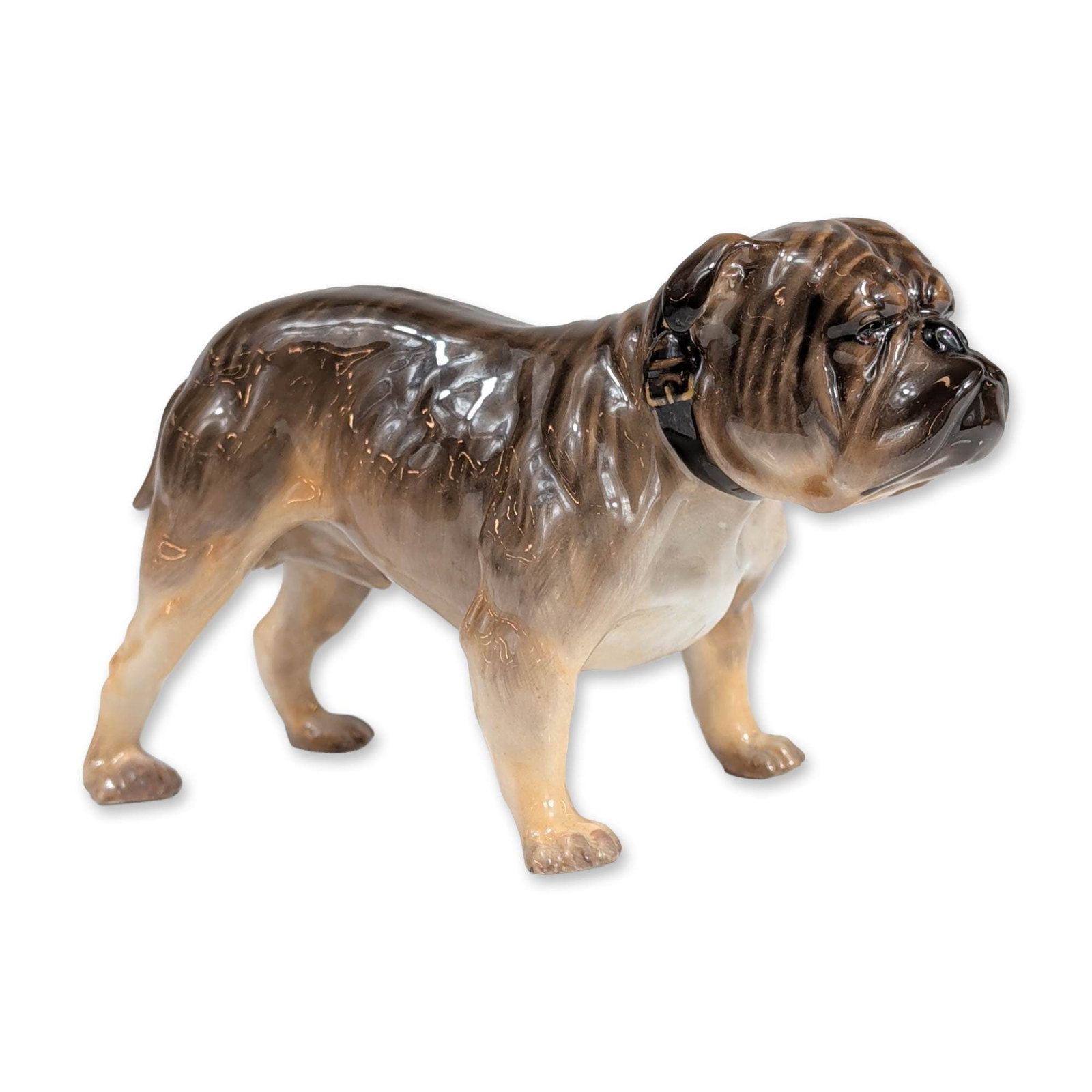 Royal Doulton Standing Bulldog Figurine HN1043: Royal Doulton. Bulldog figurine in glazed bone china, modeled in a standing position with the head tilted upward. The figure features a brindle and cream-colored coat with a lustrous finish and a pain