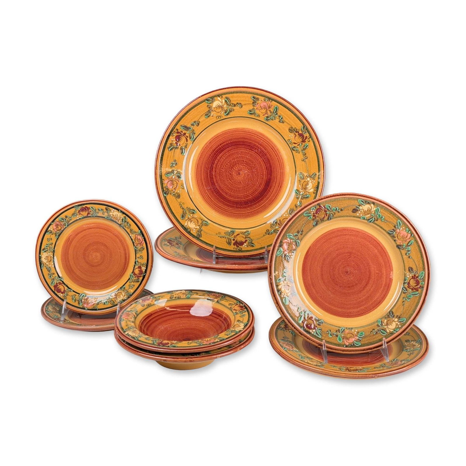 8pc Veronique Pichon Uzes Earthenware Dinnerware: Veronique Pichon, Uzes, France. Partial table service in glazed earthenware, featuring a rustic Provencal hand-painted design. Each piece is decorated with a reddish-brown spiral center and a wide mus