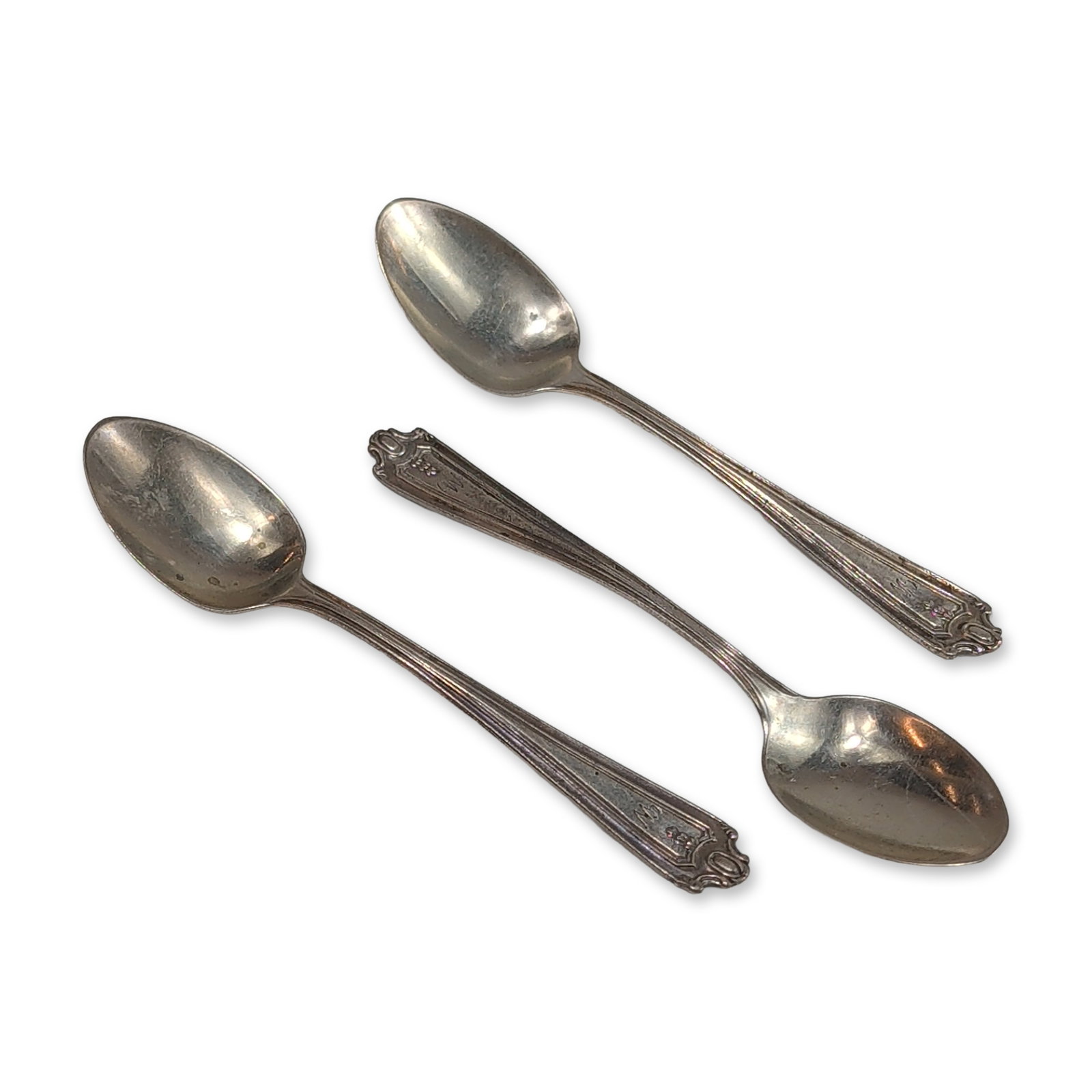 Trio of Lunt Sterling Silver Demitasse Spoons: Each spoon features a scrolled handle terminal with a blank cartouche and longitudinal ribbing along the stem. Oval bowls. Reverse of handles stamped with hallmark STERLING. Length: 4.5 inches each. T