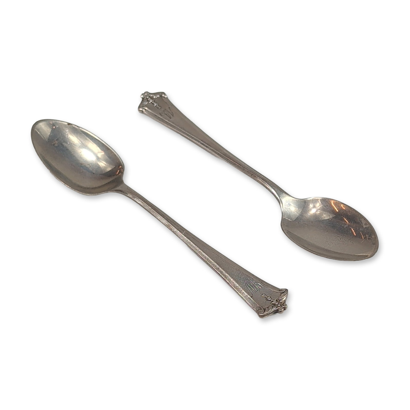 2pc Lunt Sterling Silver Demitasse Spoons: Demitasse spoons in sterling silver, featuring a floral pattern with scrolled handle terminals and raised relief decoration. Each handle is engraved with a decorative script monogram stamped STERLING 