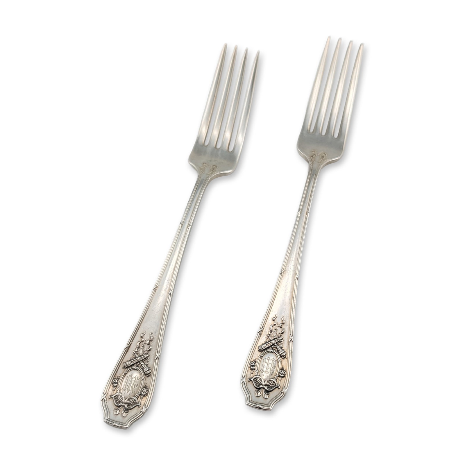 Pair of Wallace Sterling Silver Forks: R. Wallace and Sons sterling silver forks. Each handle features Neo-Classical relief decoration with a central oval cartouche containing a script monogram, surmounted by a ribbon bow and floral swags,