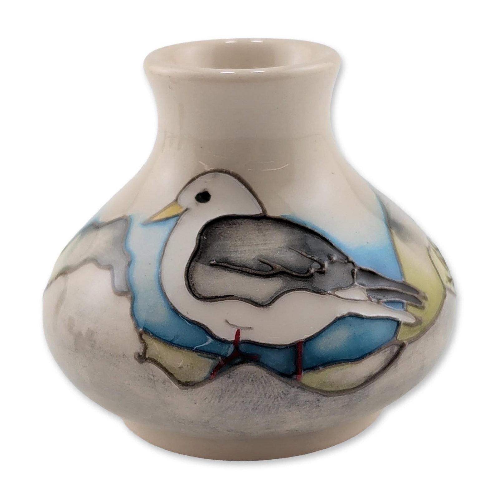 Moorcroft Pottery Miniature Vase, Kittiwake: Moorcroft Pottery, England. Miniature bulbous vase in tubelined earthenware, featuring the Kittiwake pattern depicting an adult bird and two chicks in a nest within a coastal landscape. Hand-painted i