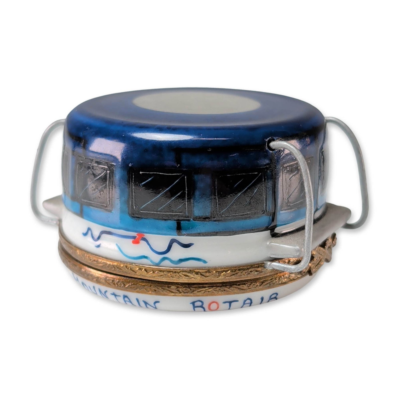 Limoges Hand Painted Porcelain Cable Car Trinket Box: Limoges, France, hinged trinket box in hand painted porcelain, modeled in the form of the Table Mountain Rotair cable car. The exterior is decorated in shades of blue with black and silver windowpanes