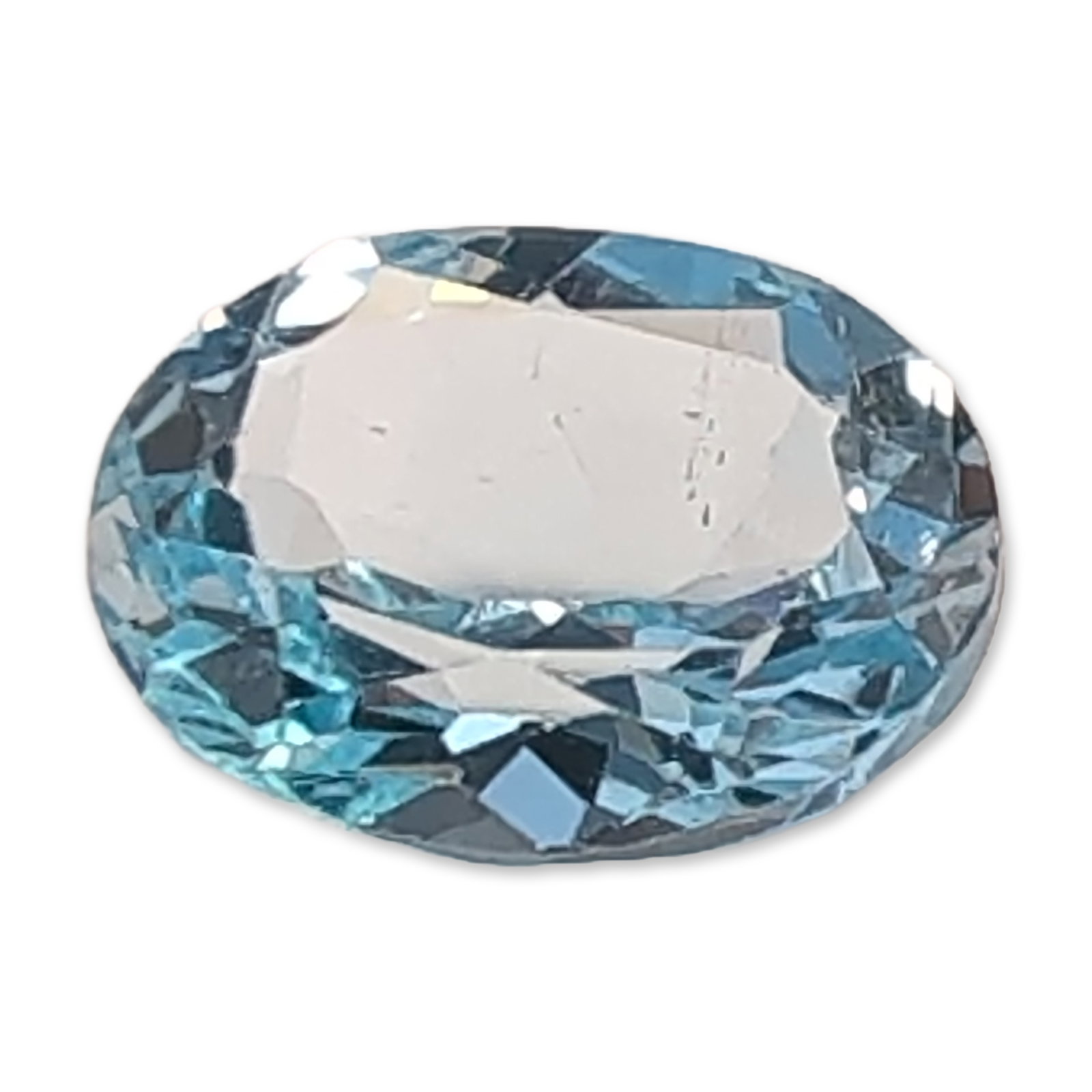 Loose Oval Faceted Light Blue Sapphire Gemstone: Loose faceted Sapphire gemstone featuring an oval faceted cut with a well-proportioned crown and a deep pavilion. The stone exhibits high transparency and a vitreous luster. No inclusions are visible