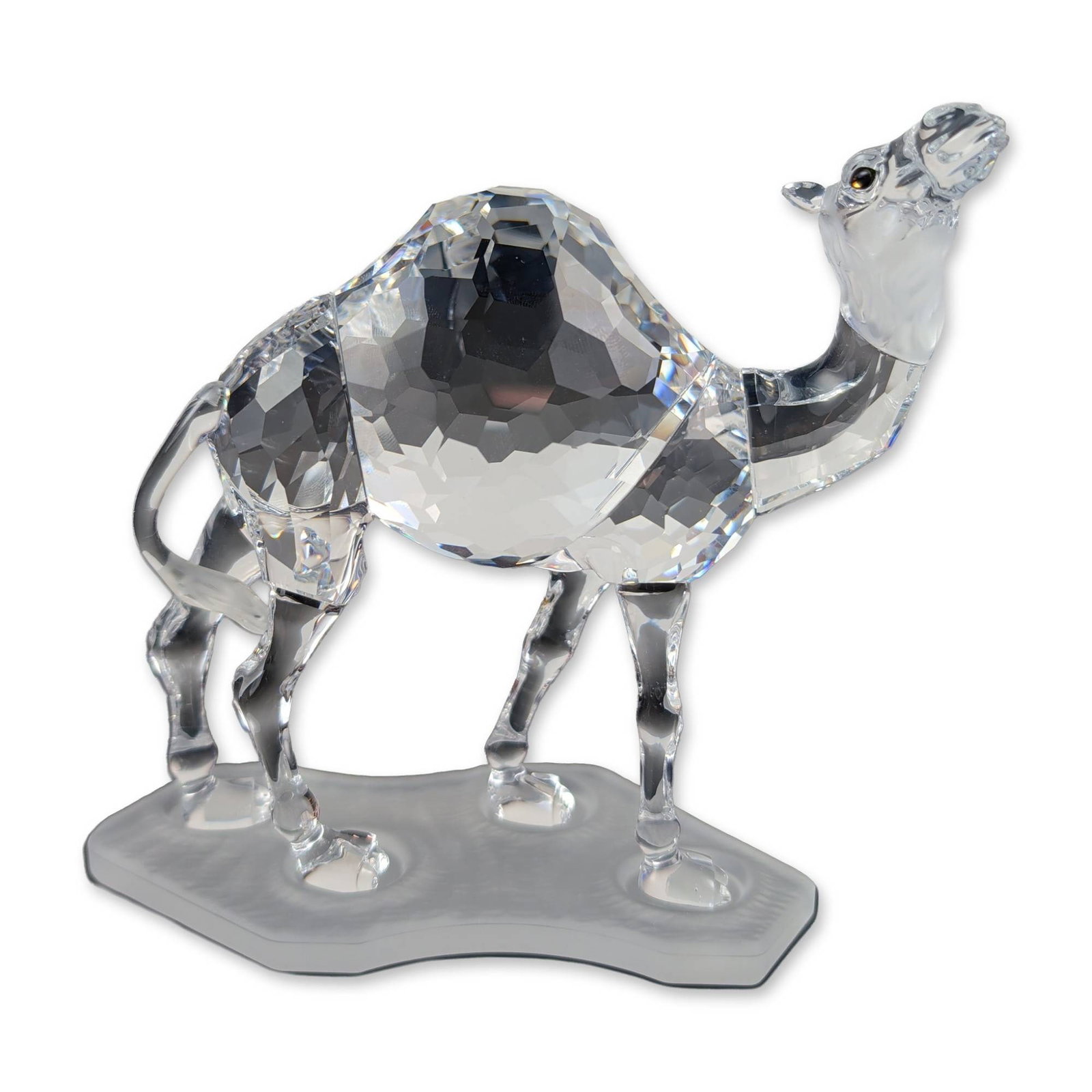 Swarovski Silver Crystal Camel Figurine: Swarovski Silver Crystal collection. Dromedary camel figurine in faceted and molded clear lead crystal, featuring a faceted humped body and neck, molded head with dark crystal eyes, and four legs secu