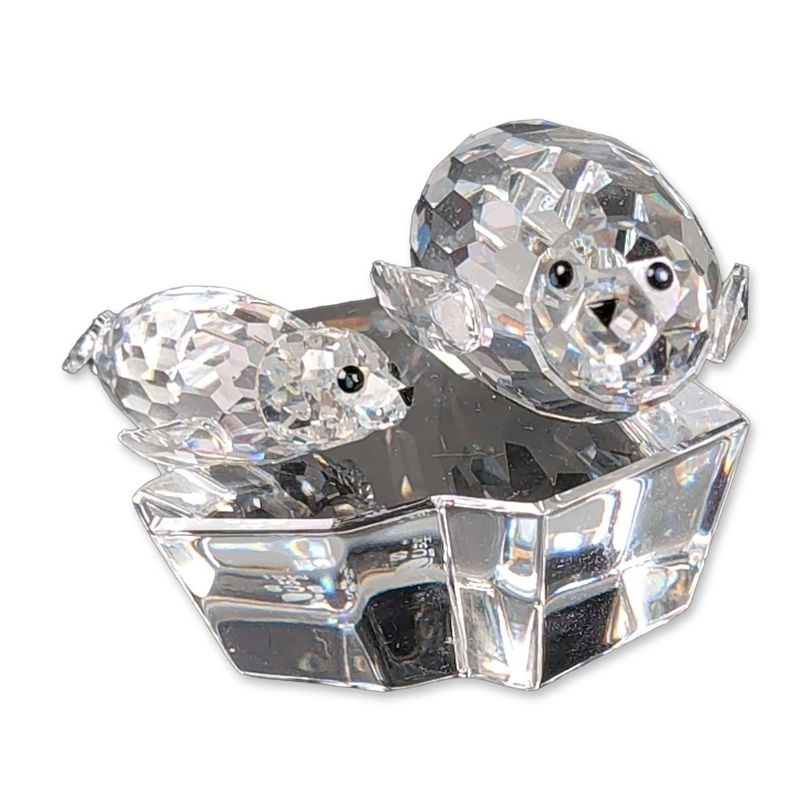 Swarovski SCS 1991 Annual Edition Crystal Figurine, The Seals - Save Me: 1991 Annual Edition figurine titled The Seal, the second release in the Mother and Child trilogy. Faceted lead crystal construction featuring a mother seal and her pup on a faceted iceberg base. Figur