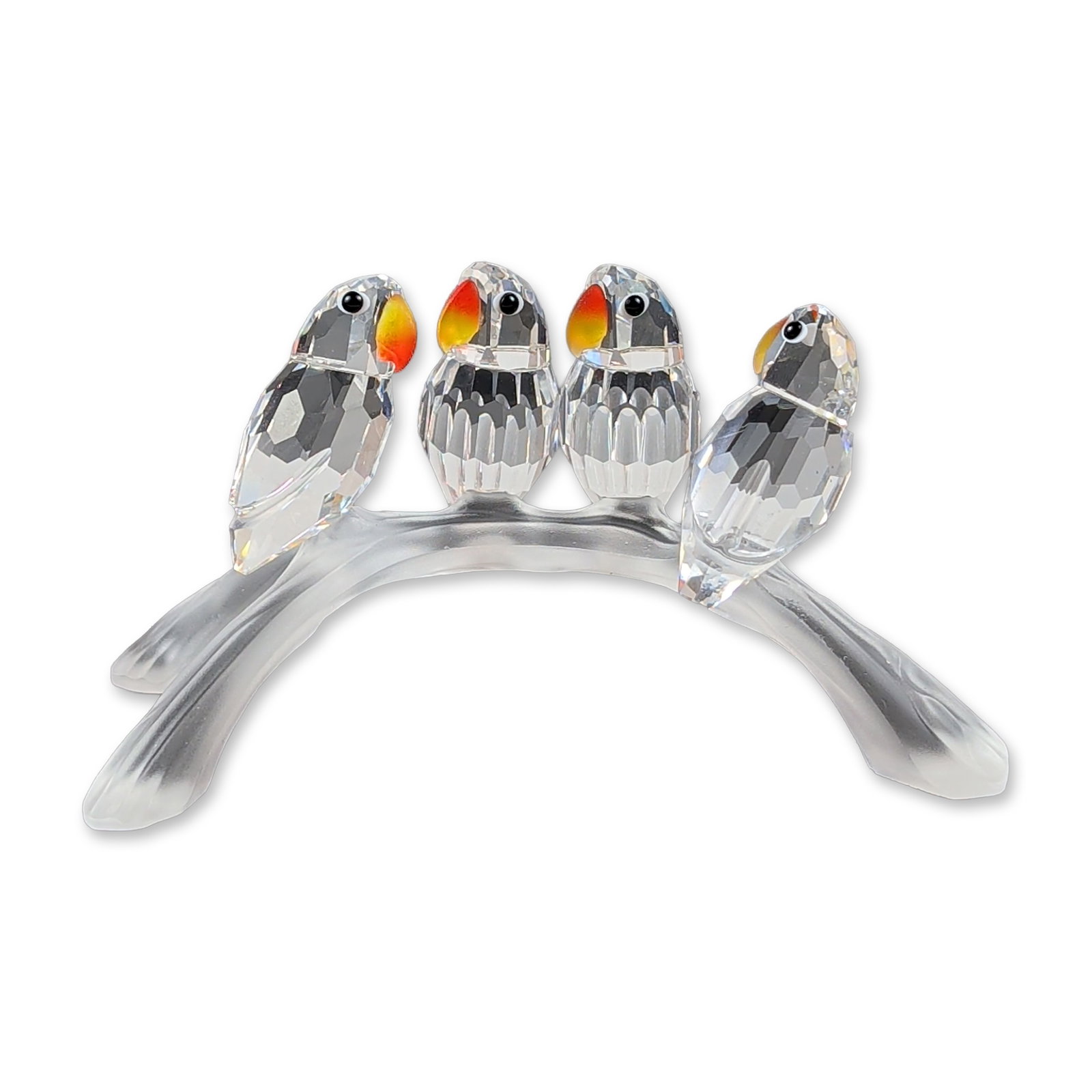Swarovski Crystal Baby Lovebirds on Frosted Branch: Swarovski lead crystal figurine titled Baby Lovebirds on Branch, featuring four stylized birds with clear faceted bodies, black bead eyes, and frosted beaks with an orange-to-yellow gradient. The bird