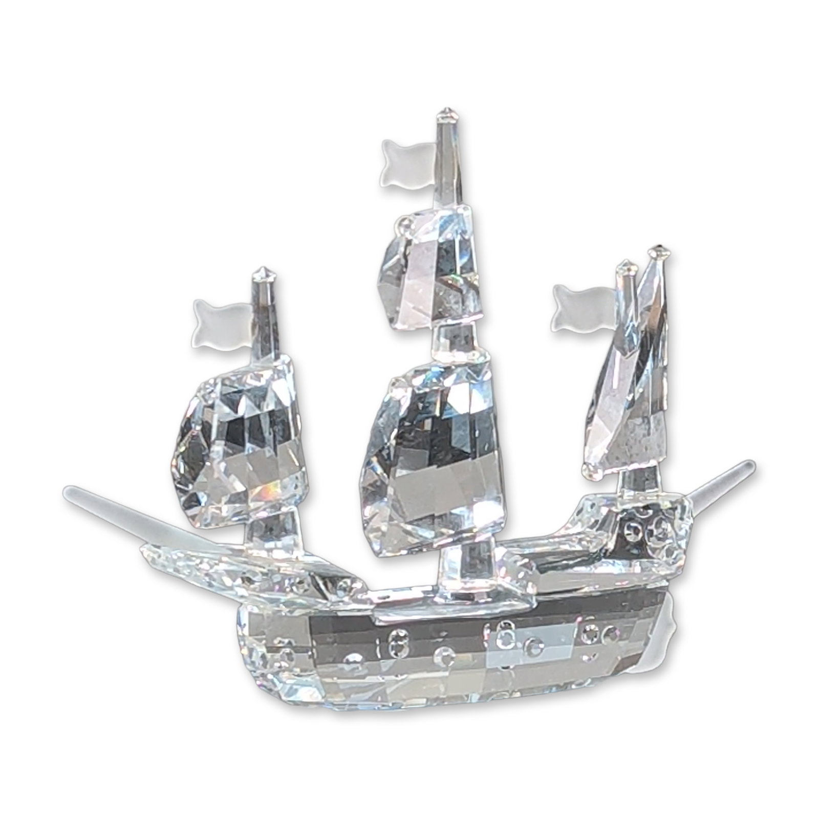 Swarovski Crystal Figurine, Santa Maria Sailing Ship: Swarovski Silver Crystal from the When We Were Young series. The three-masted ship features clear faceted sails and a molded hull with internal bubble details. Includes a rectangular mirrored display 
