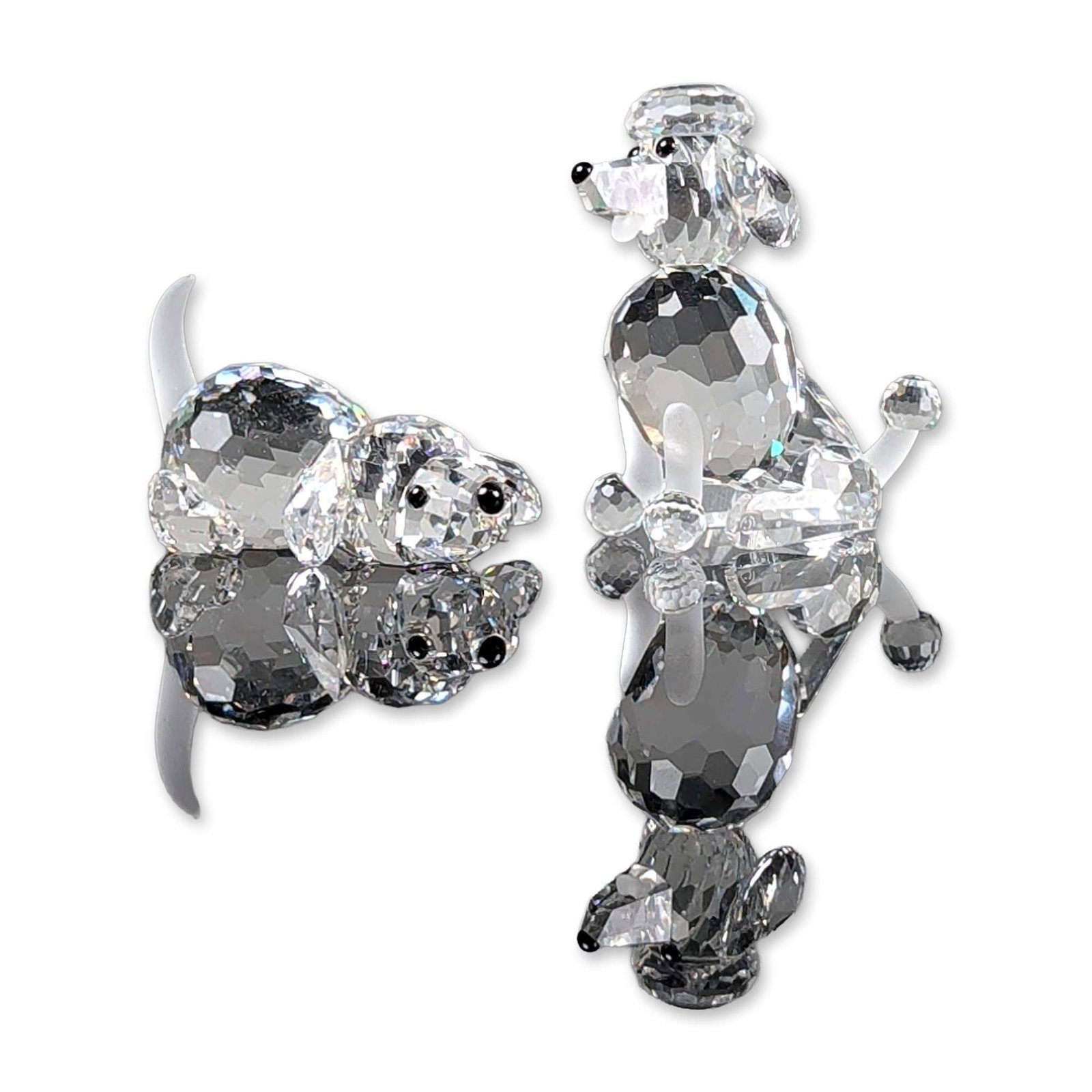2pc Swarovski Silver Crystal Dog Figurines, Poodle and Beagle Puppy: Two crystal dog figurines crafted from multi-faceted and frosted lead crystal. One poodle is depicted in a standing posture with frosted crystal accents on the paws, tail tip, and head topknot. The se