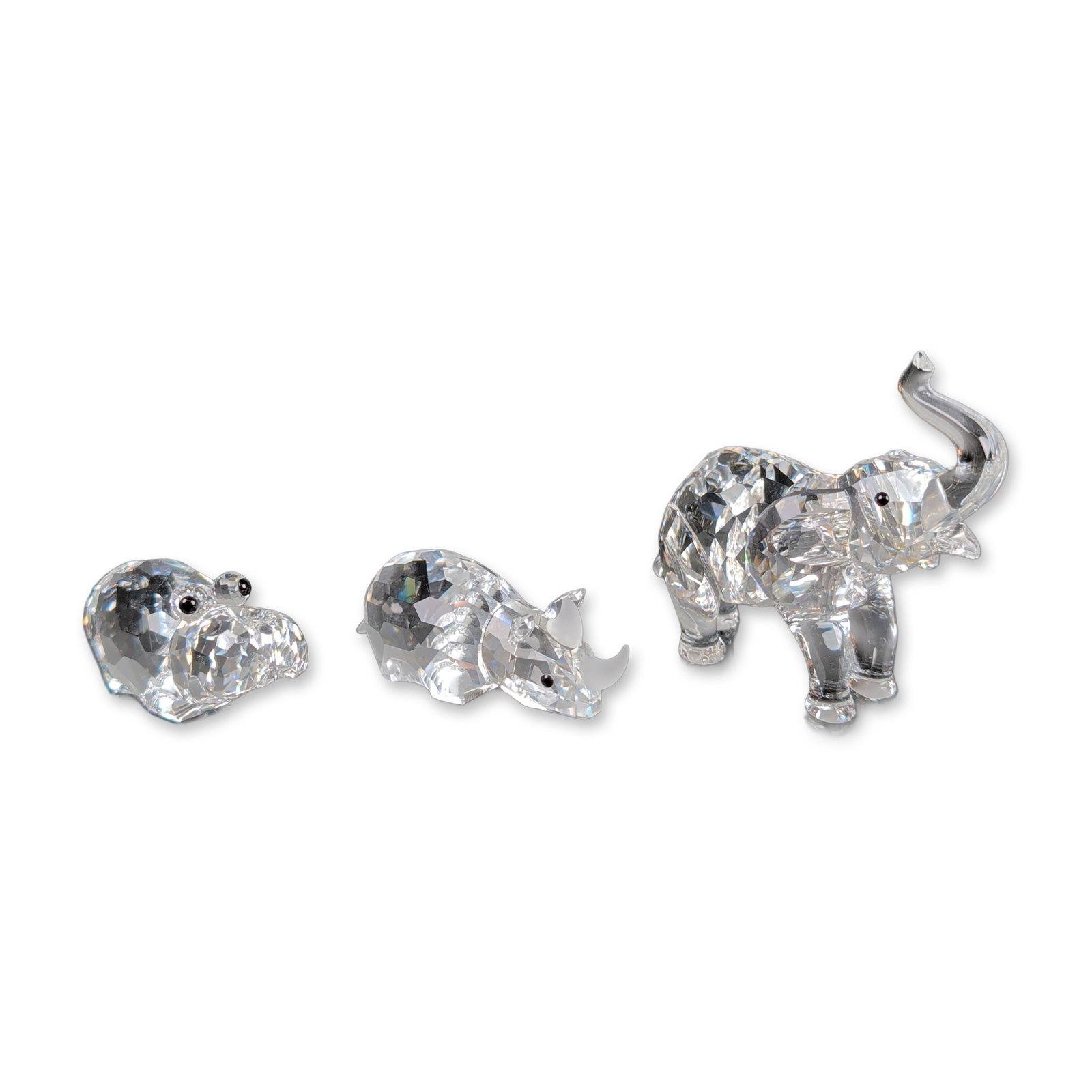 3pc Swarovski Crystal Animal Figurines, Hippo, Elephant & Rhino: Three faceted lead crystal animal figurines from the Silver Crystal collection. The lot consists of an baby elephant with an upright trunk and frosted tusks, a rhinoceros with frosted horns, and a sta