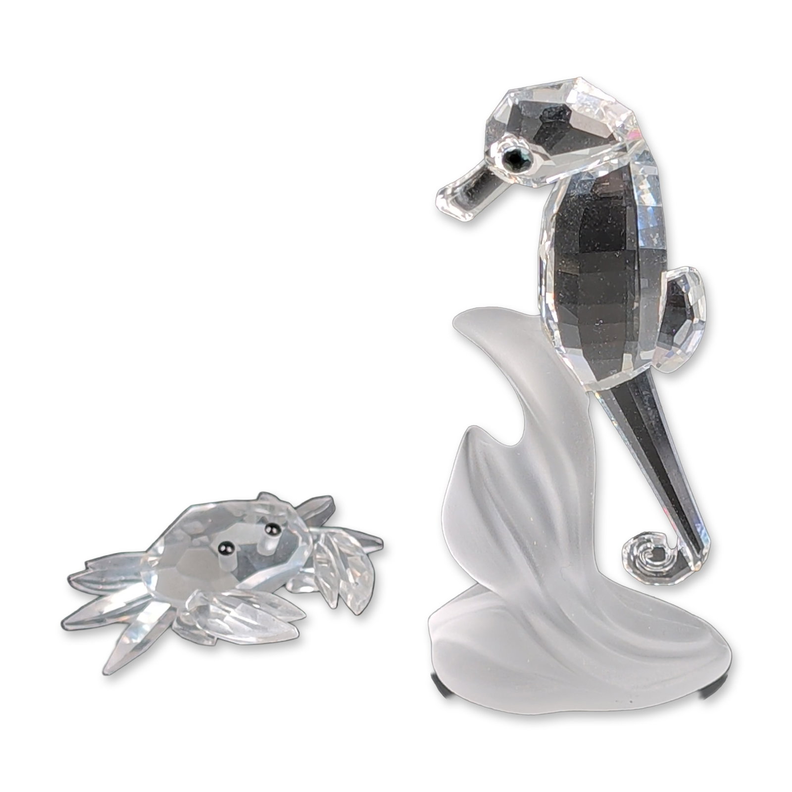 2pc Swarovski Silver Crystal Seahorse and Crab: Swarovski. Two marine themed figurines in faceted clear lead crystal from the Silver Crystal collection. Includes one seahorse figurine positioned on a frosted crystal wave base and one smaller crab f