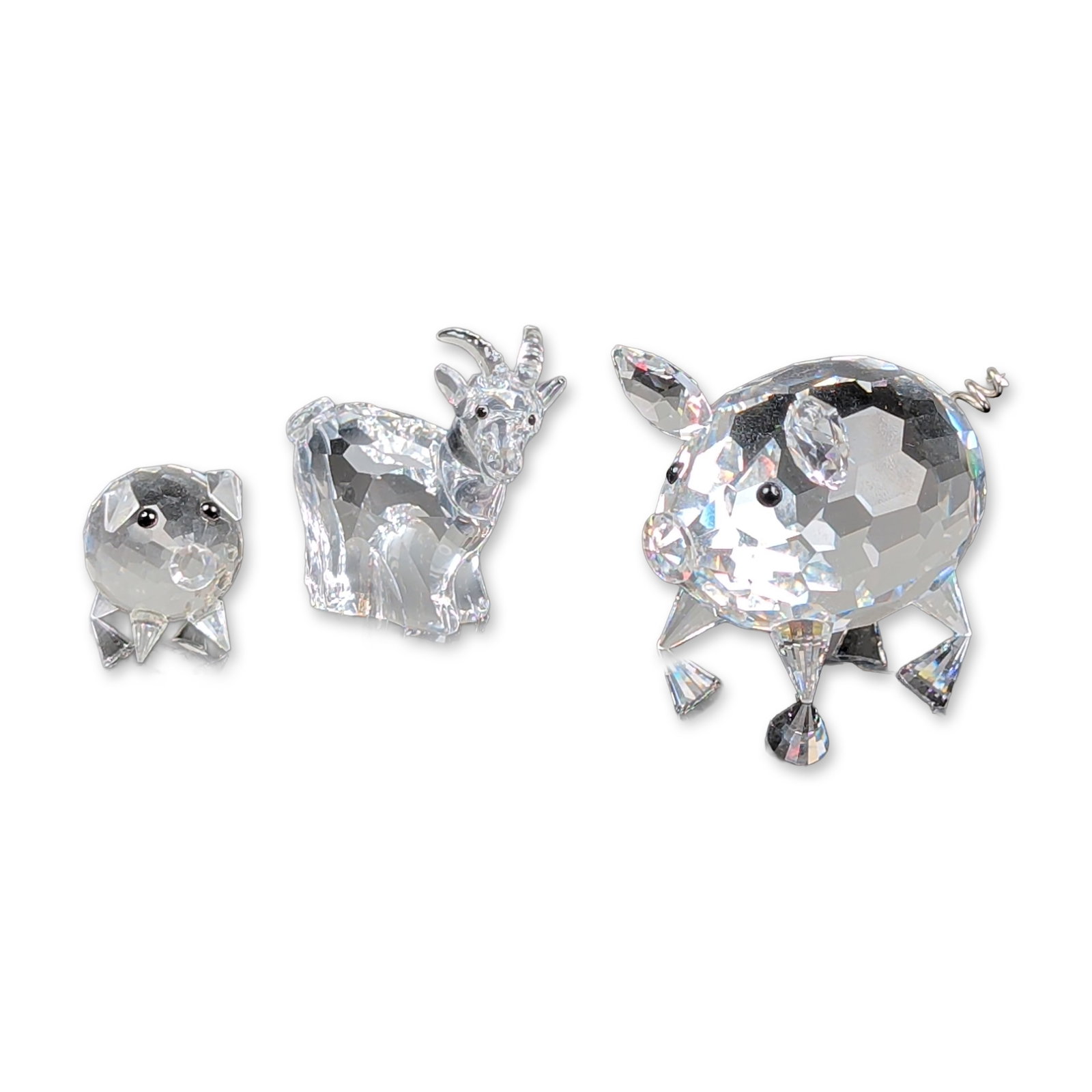 3pc Swarovski Silver Crystal Barnyard Animal Figurines: Swarovski Silver Crystal animal figurines including a large pig, a small pig, and a standing goat. Each piece is crafted from faceted clear lead crystal, with the pigs featuring coiled metal wire tail