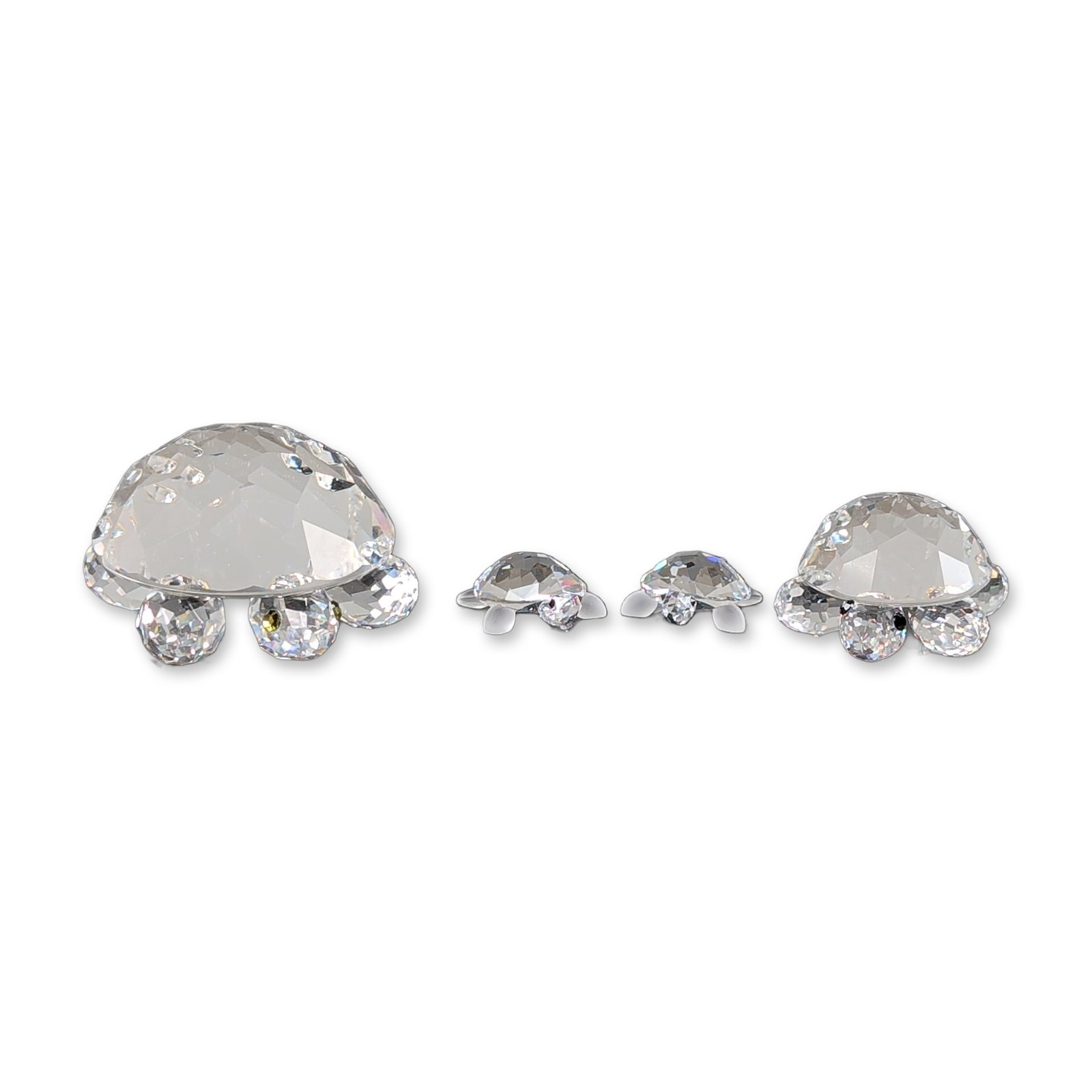 4pc Swarovski Faceted Crystal Turtles Figurines: Swarovski set of four graduated turtle figurines in clear faceted crystal. The collection consists of one large turtle, one medium turtle, and two miniature turtles. The two larger examples are constr