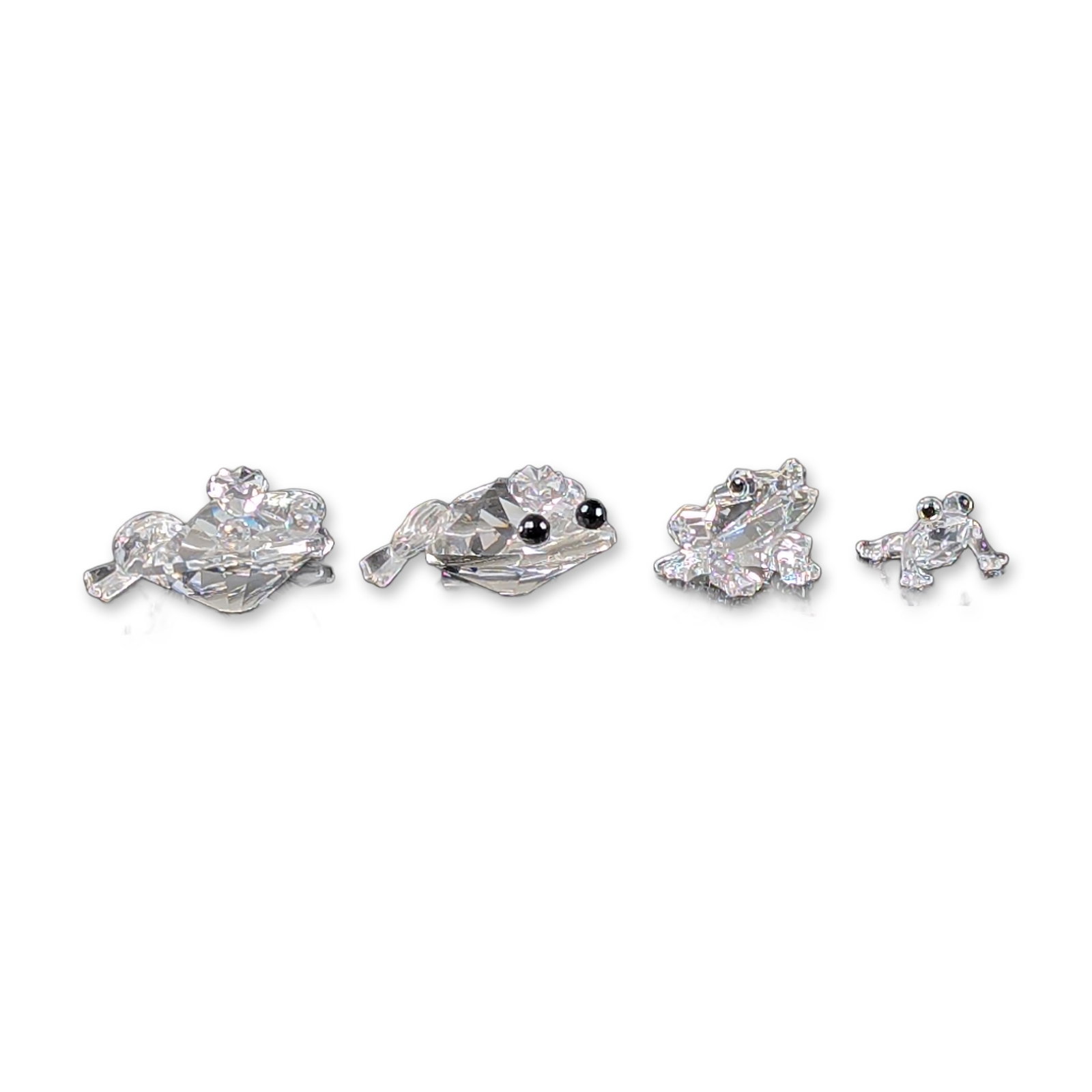 4pc Swarovski Silver Crystal Frog Figurines: Set of four frog figurines include Frog Prince, Frog Prince clear eyes, Mini Frog with green eyes and Baby Frog. Crystal faceted frogs with clear crystal bodies, black or colored crystal eyes. The set