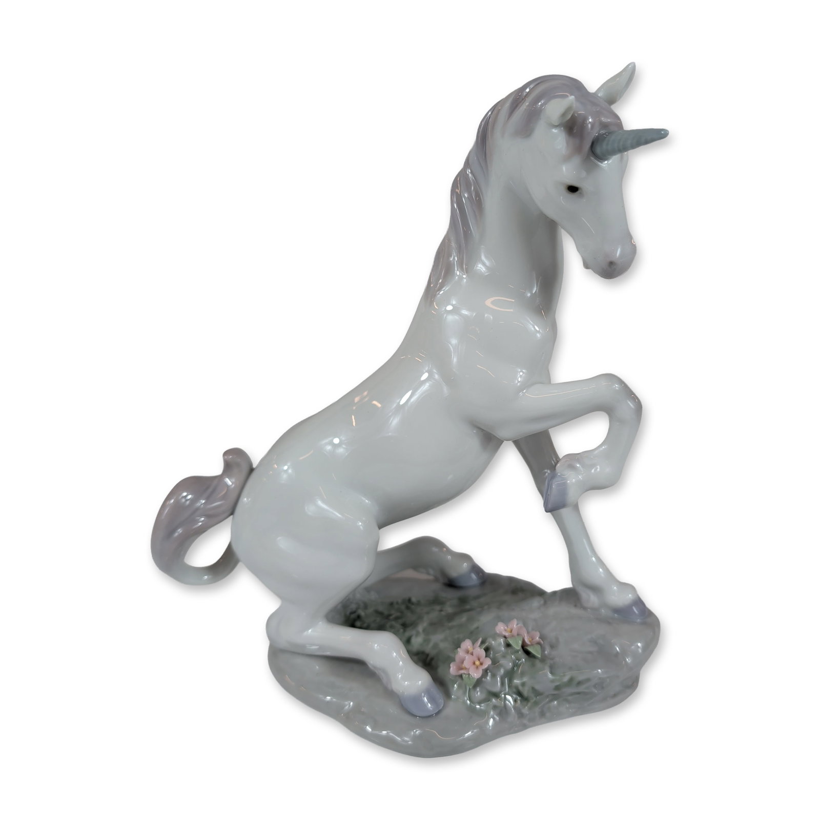 Lladro Privilege Porcelain Magical Unicorn Figurine 7697: Lladro Privilege Magical Unicorn, model number 7697. Glazed porcelain figurine depicting a rearing unicorn with lavender-grey mane, tail, and hooves, and a light blue horn. The figure is set on a text