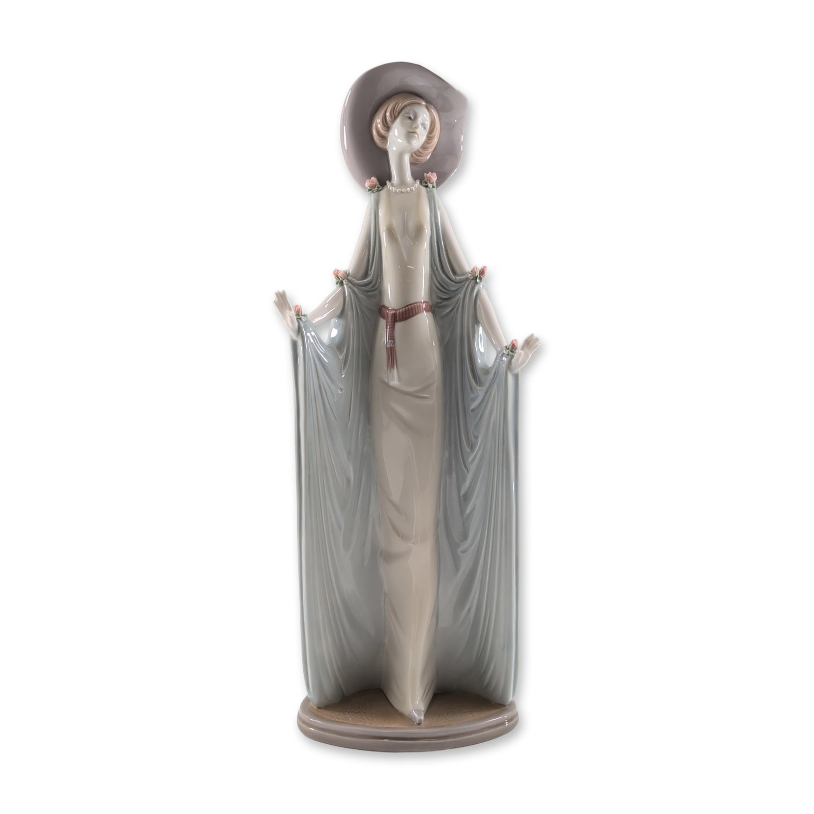 Lladro Afternoon Tea Porcelain Figurine: Lladro glazed porcelain figurine, model number 1428, titled Afternoon Tea and designed by Jose Puche. This tall lady figure is rendered in an Art Deco style, featuring an elongated pose with a form-fi