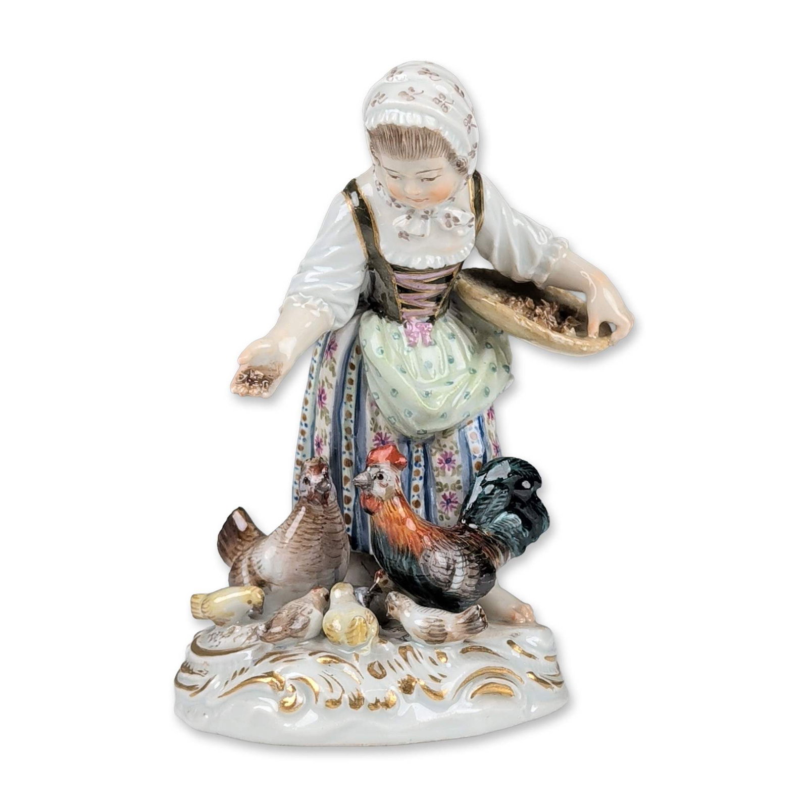 Meissen Porcelain Figurine, Girl Feeding Chickens 2814: A Meissen porcelain figurine, model 2814, that depicts a young woman feeding poultry in 18th-century rural attire, featuring a lace-trimmed cap, dark bodice with gilded lacing, pale green apron, and a