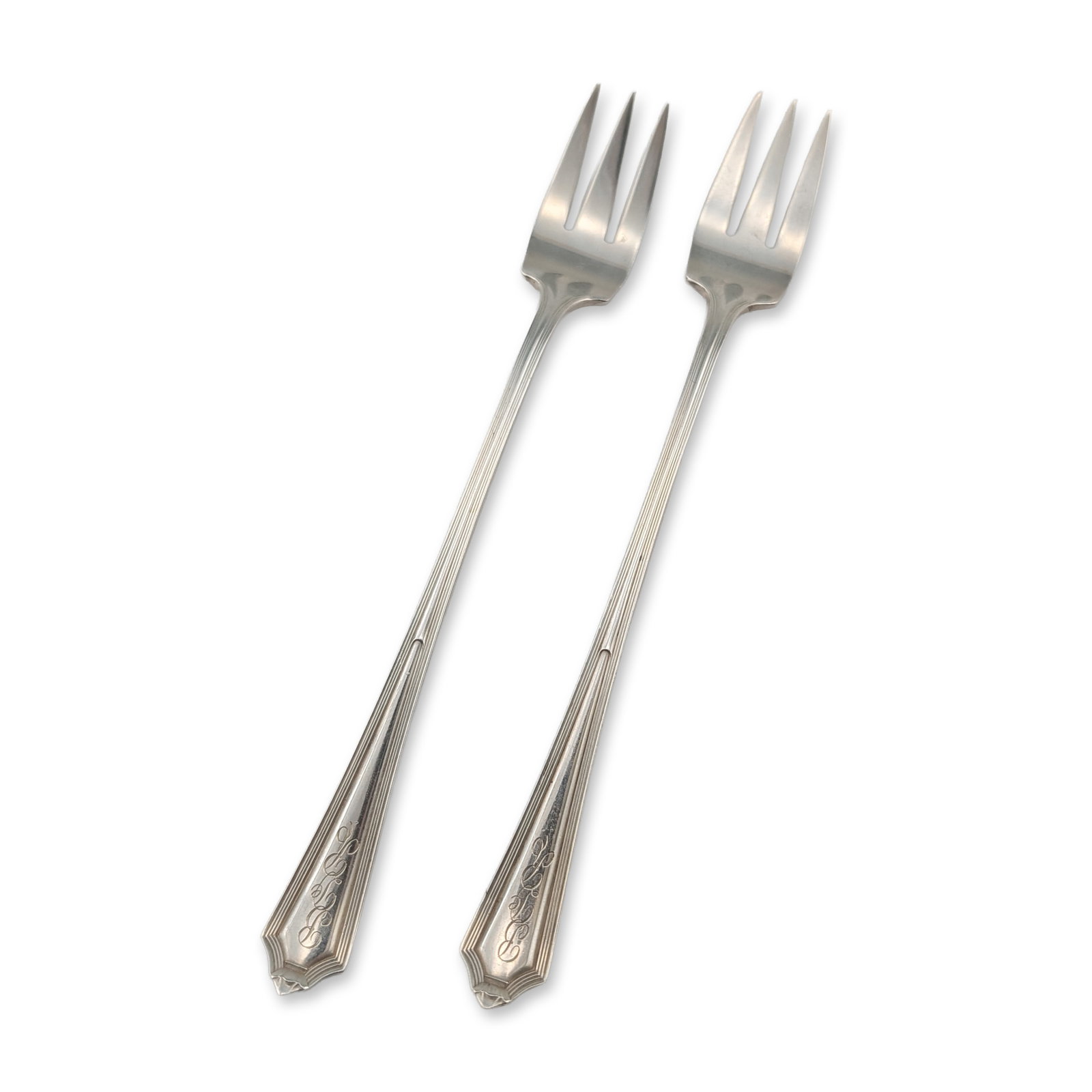 Pair of Gorham Sterling Silver Plymouth Cocktail Forks: Gorham Manufacturing Company. Pair of cocktail or oyster forks in sterling silver, featuring the Plymouth pattern. Each fork consists of three tines and a slender handle with vertical reeding flaring 