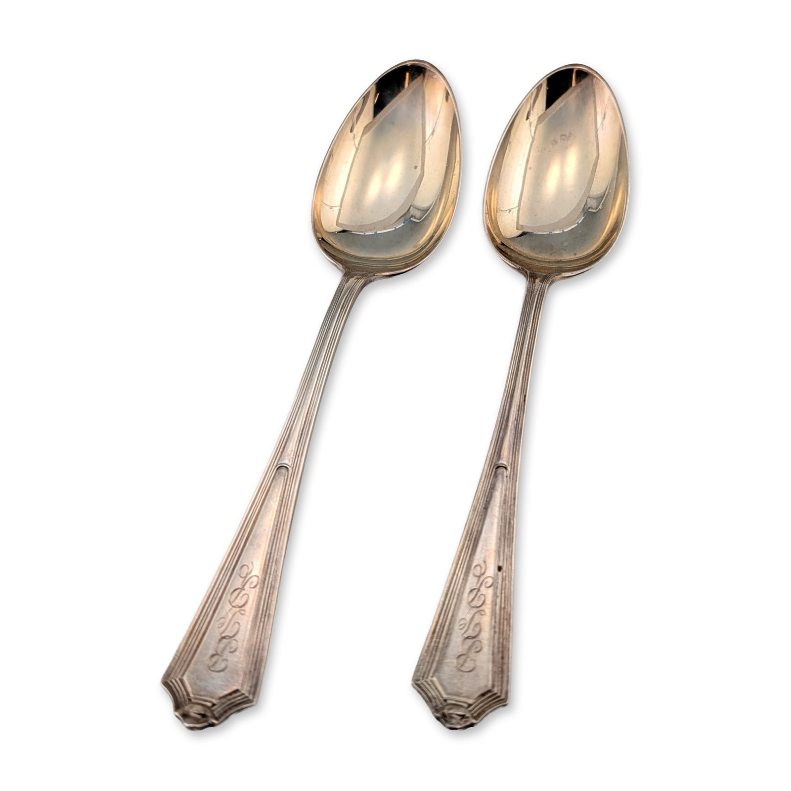 2pc Gorham Sterling Silver Plymouth Art Deco Tablespoons: Gorham Manufacturing Company. Pair of tablespoons in sterling silver, featuring the Plymouth design with tapered handles, vertical reeded lines, and pointed, stepped finials. The front of each handle 