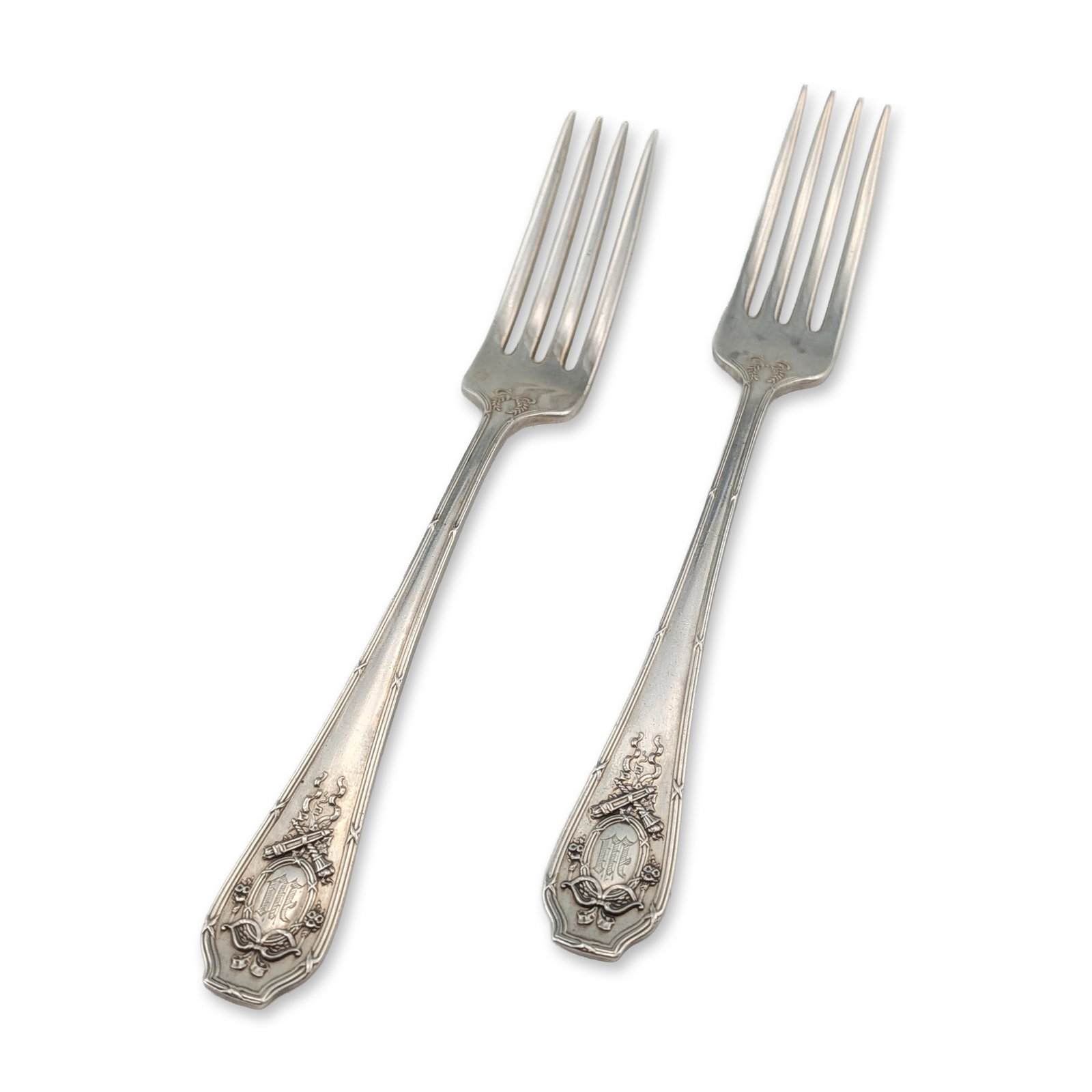 Pair of Wallace Sterling Silver Forks: Pair of R. Wallace & Sons sterling silver forks. The handles feature Art Nouveau relief decoration including crossed torches, ribbons, and swags, with a central Gothic-style monogram letter W. Marks o