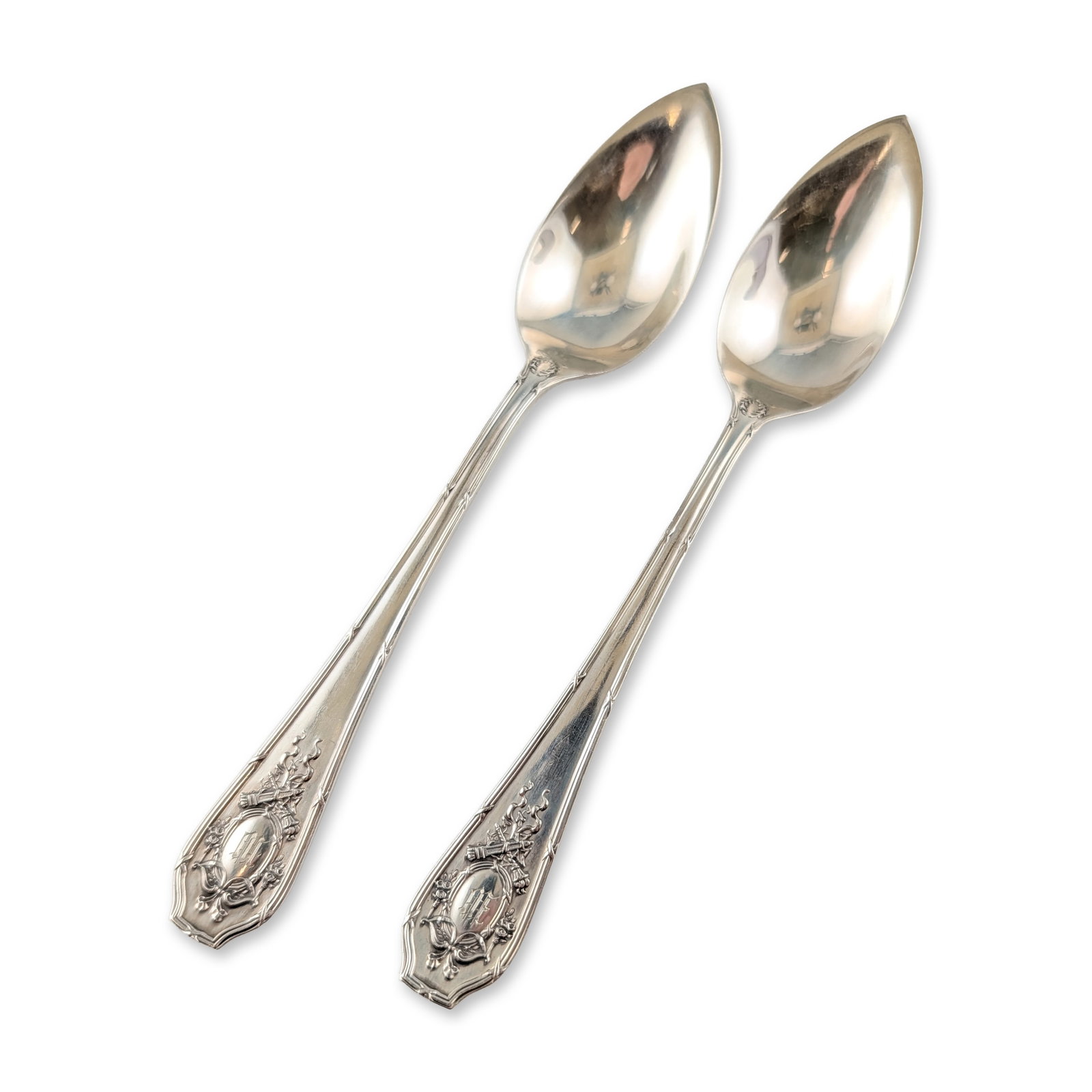 2pc Wallace Sterling Silver Citrus Spoons: R. Wallace and Sons Manufacturing Co. Pair of sterling silver citrus or grapefruit spoons featuring pointed bowls and decorative handles. The Neoclassical design includes relief work of ribbon bows an